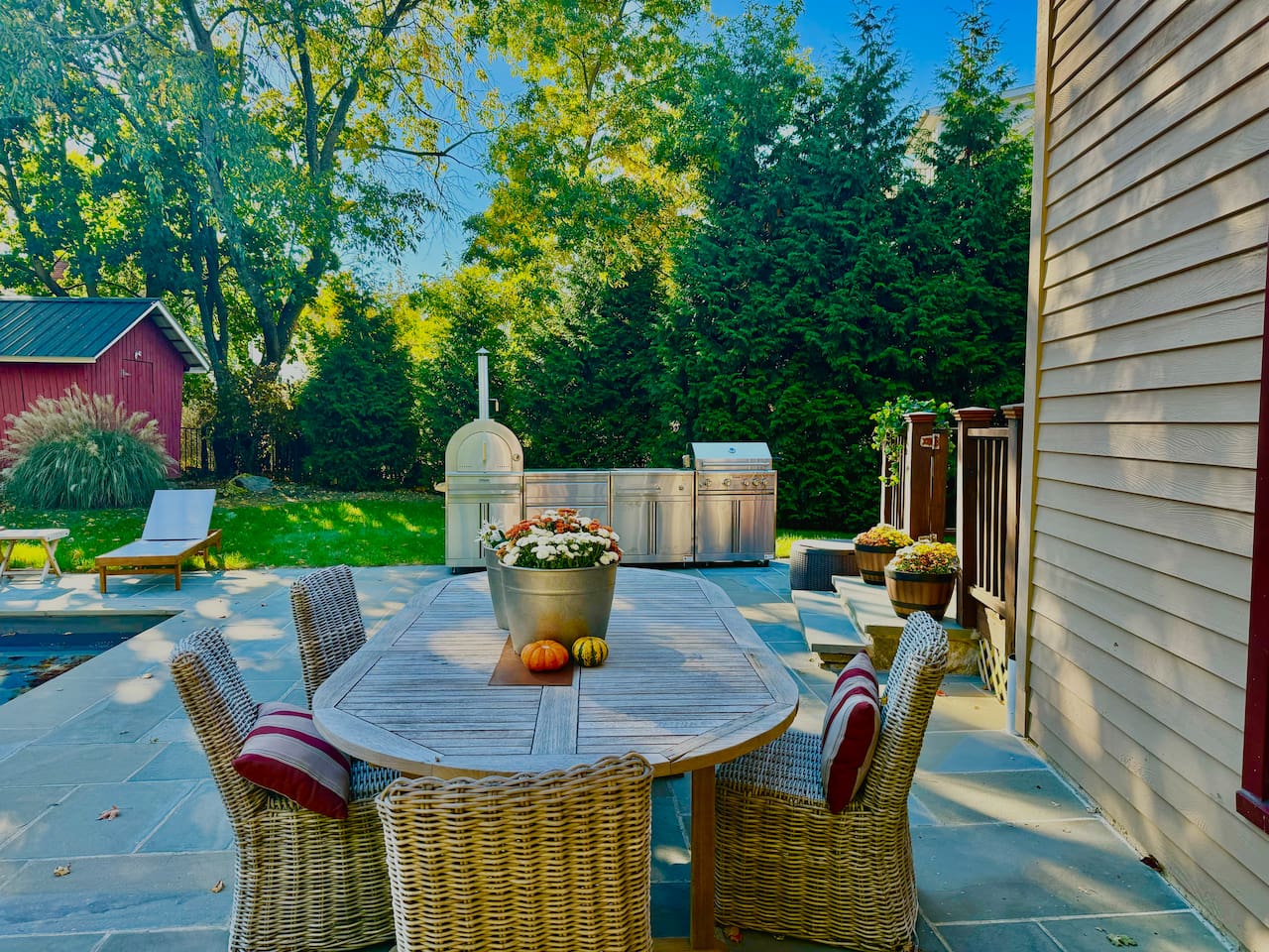 Outdoor table, outdoor kitchen with a grill and pizza oven