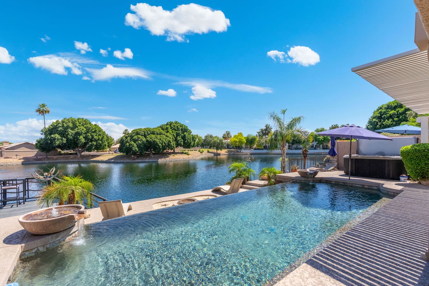 The pool's edge seems to dissolve right into the lake beyond — a seamless blend of water, sky, and desert landscape that's almost too beautiful to be real.