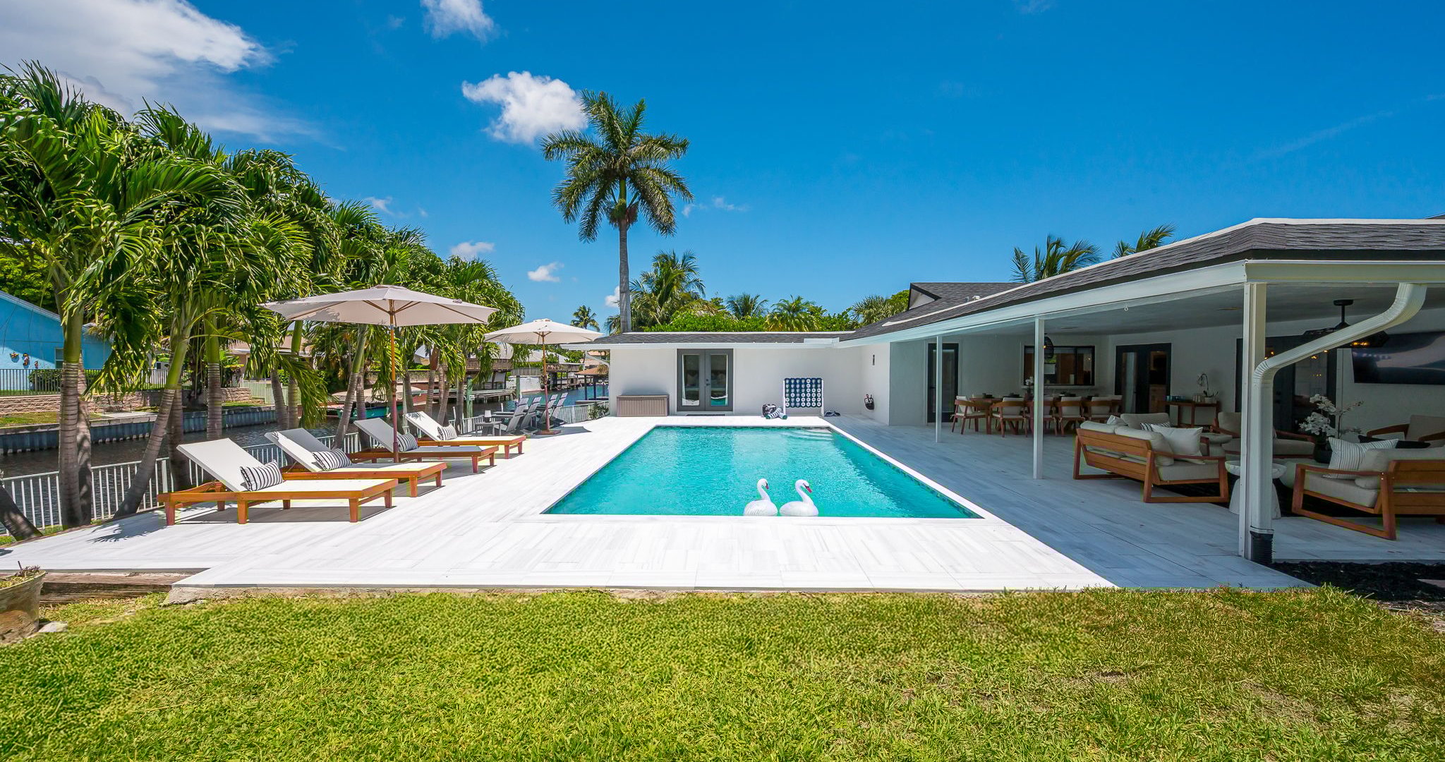 Spend your days lounging by the shimmering pool, dining al fresco under the covered patio, and unwinding in stylish outdoor living spaces—all set against a serene lakefront backdrop with private dock access