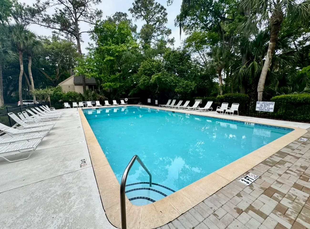 Community pool with lounge chairs