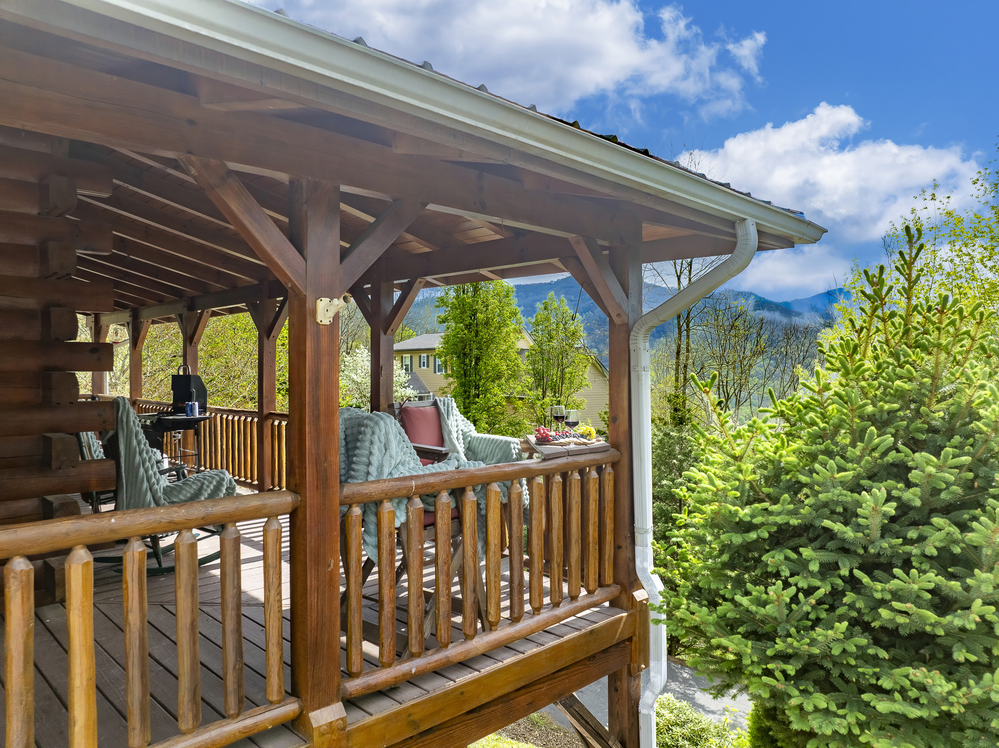 Porch Paradise: Unwind on the spacious deck with stunning mountain views and inviting seating!