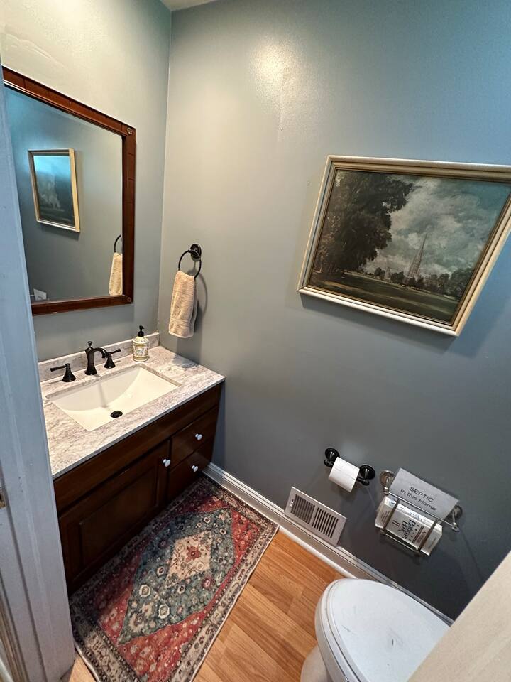 3rd Bathroom which has a sink and toilet (1/2 bath) on the first floor next to the kitchen