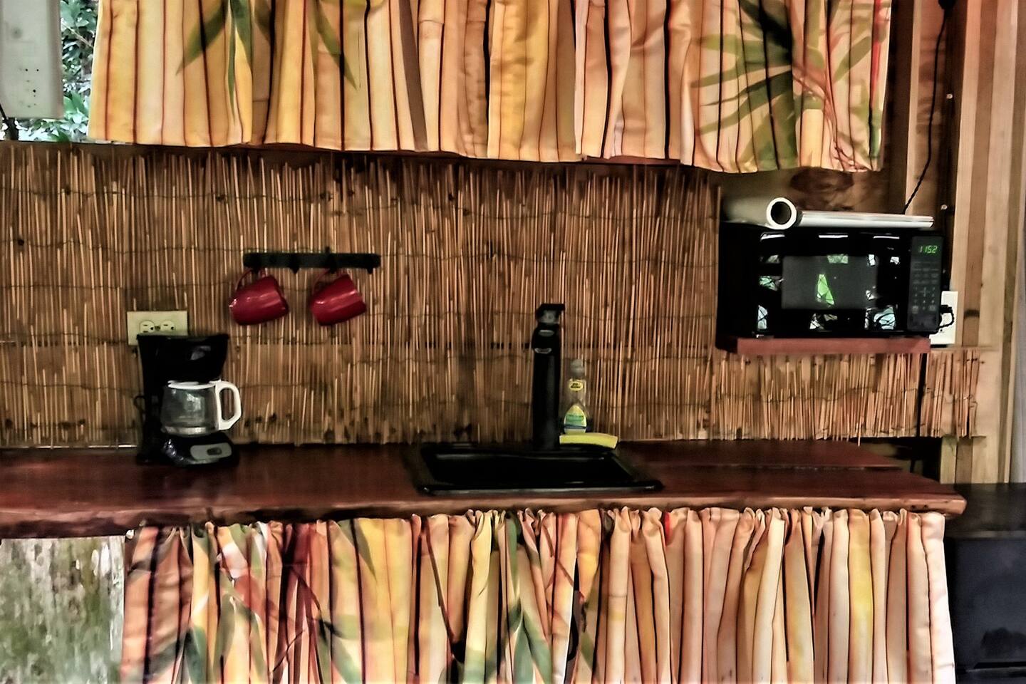 Mini Kitchen with Fridge, Microwave, electric skillet and coffee maker.