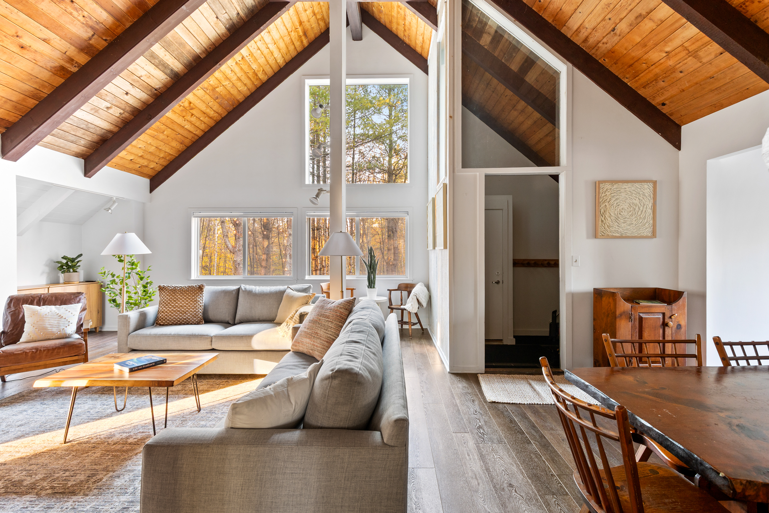 Living Room Retreat: Sunlit space with vaulted ceilings and stylish decor for perfect relaxation!