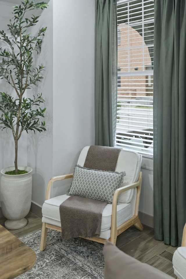 Cozy reading corner with a comfortable accent chair and natural light from the nearby window—perfect for a quiet moment with coffee or a book.