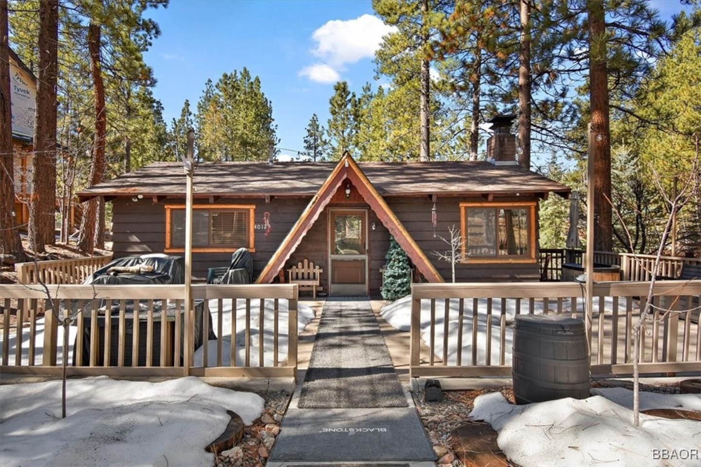 A little cabin with big cozy vibes—where snow naps on the roof and the trees stand guard like friendly giants.