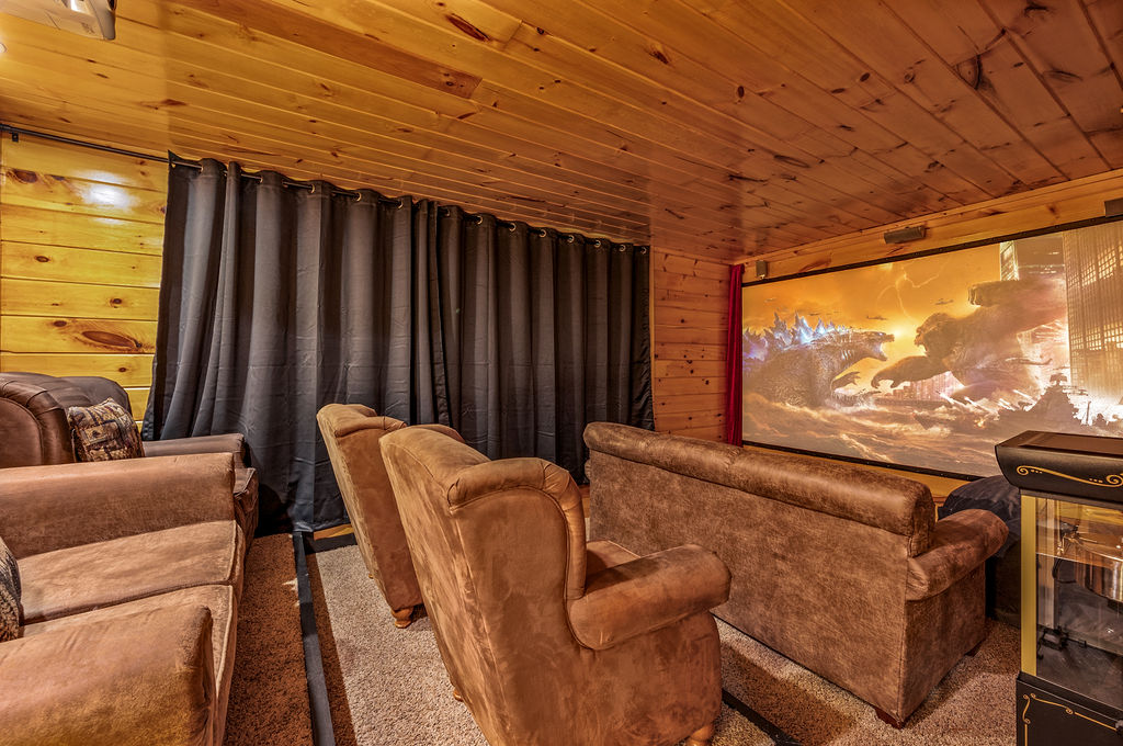 Stylish home theater setup with a big screen TV and plush couches, perfect for enjoying movies with family and friends
