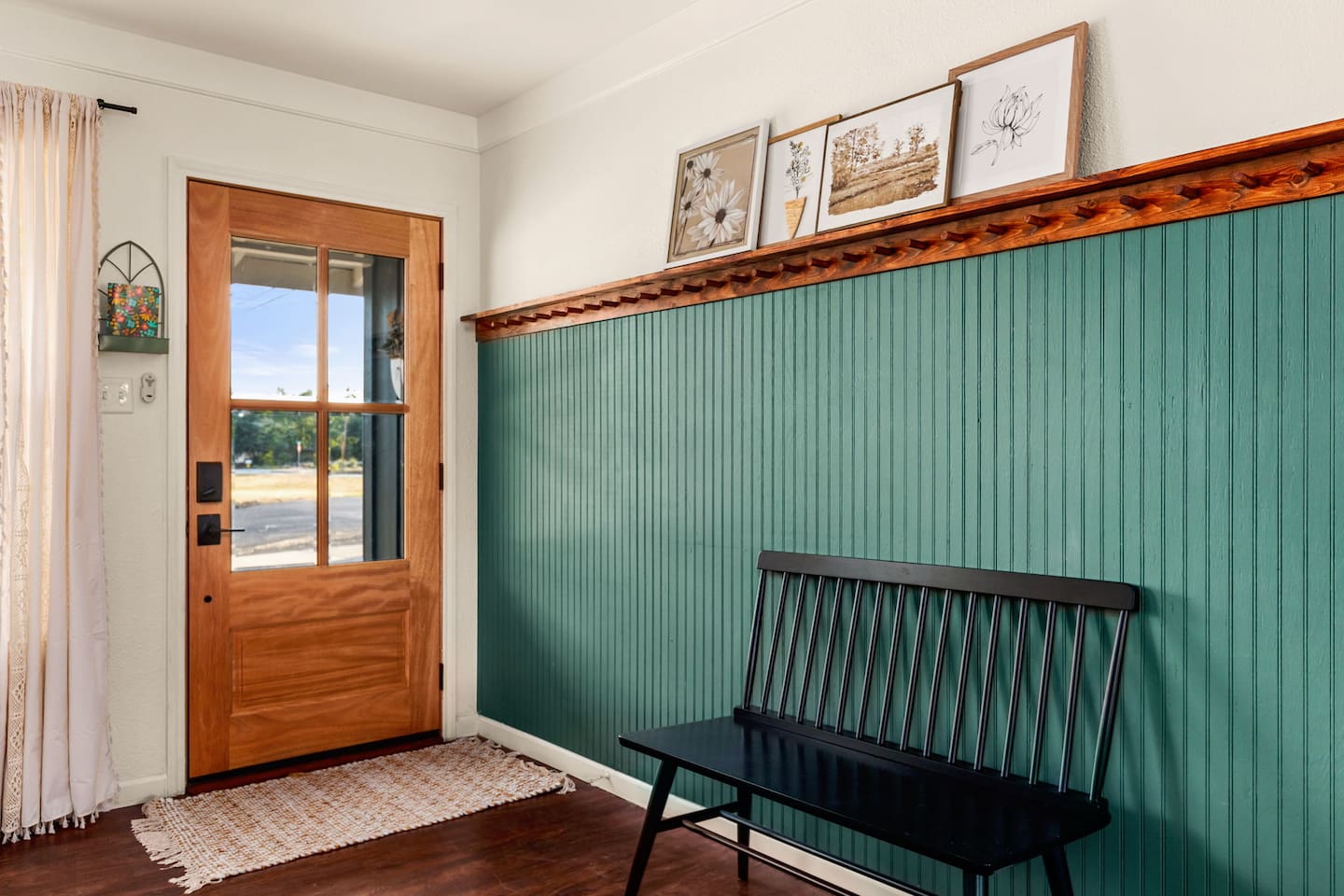 Entry accent with plenty of space to hang items, store keys, and take a seat before heading out on the town.