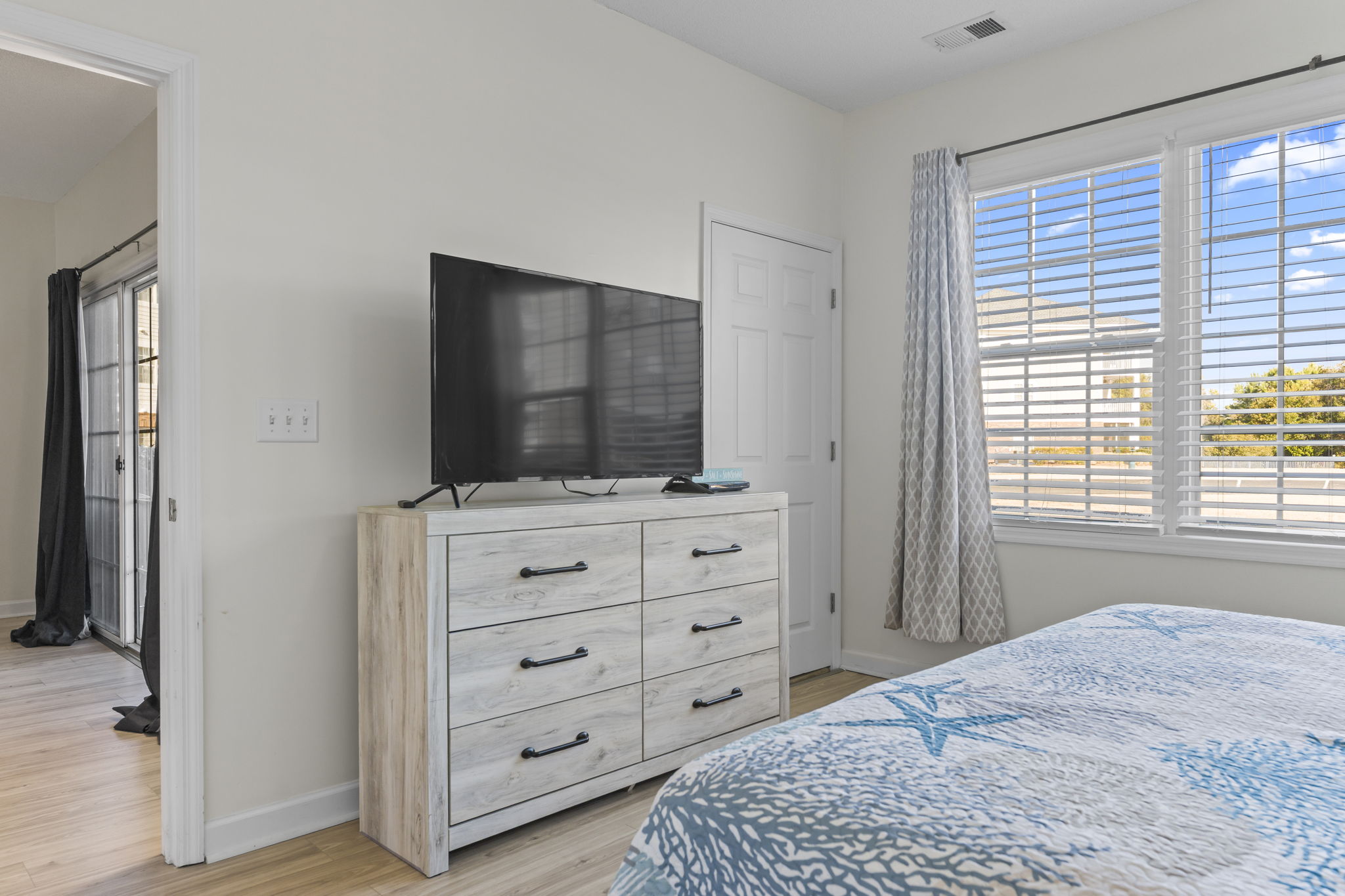 Master Bedroom with large window, king bed, ensuite bathroom