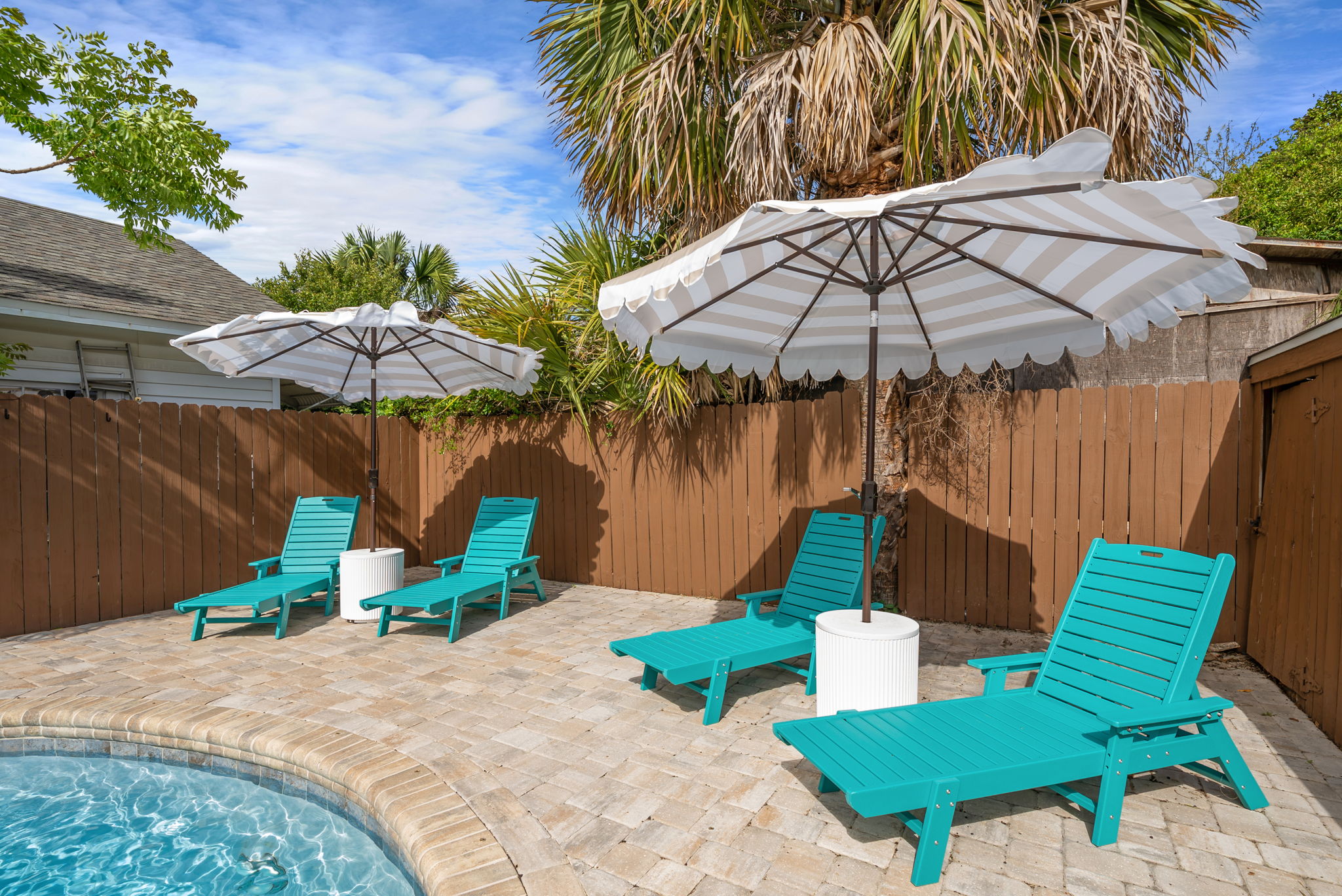 Line up all four turquoise chaise loungers for your crew and
claim your spot in the shade of a white market umbrella. Peak
relaxation mode unlocked. Don't forget your drink!