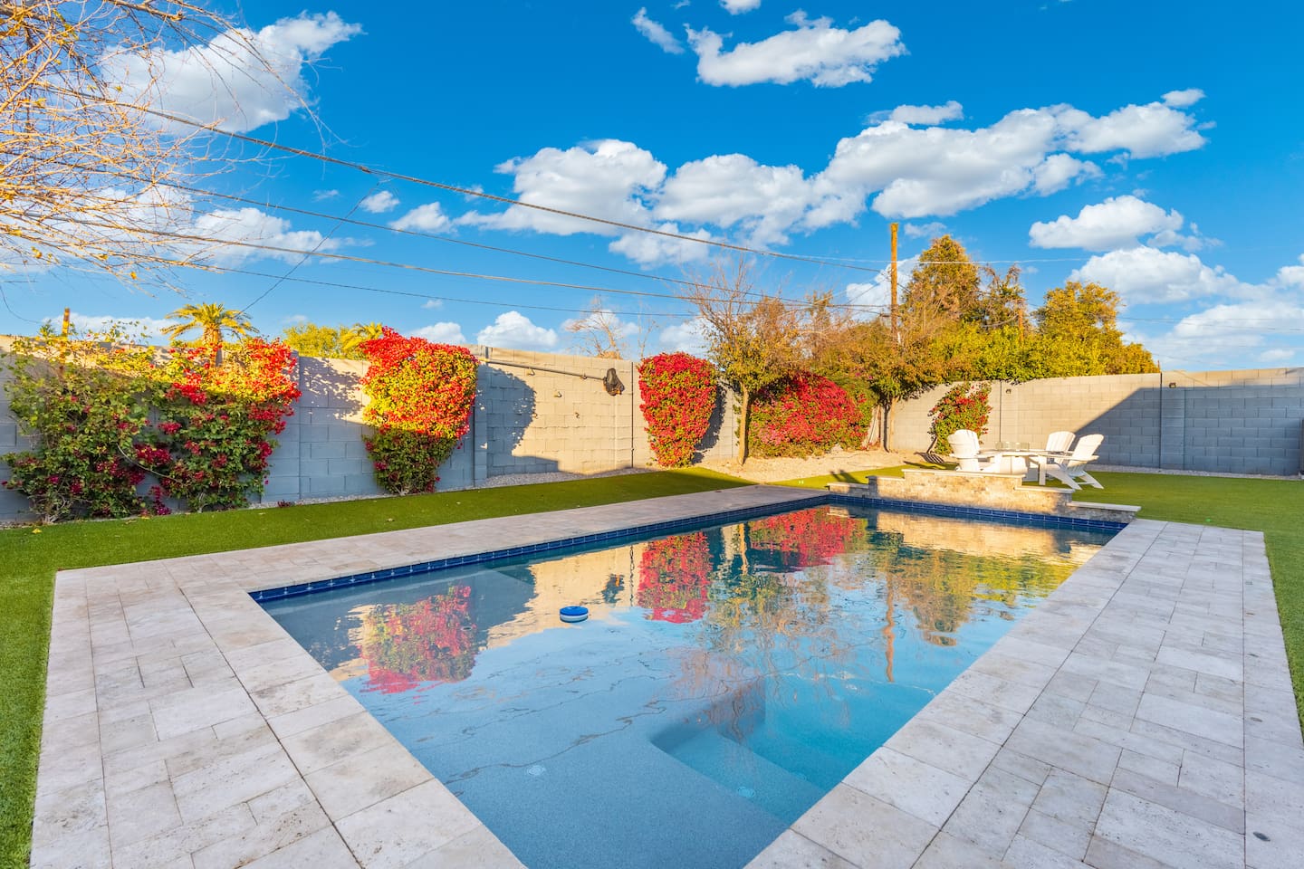 Bright daylight shining on the pool, illuminating the water and creating a lively, vibrant atmosphere perfect for a sunny day.
