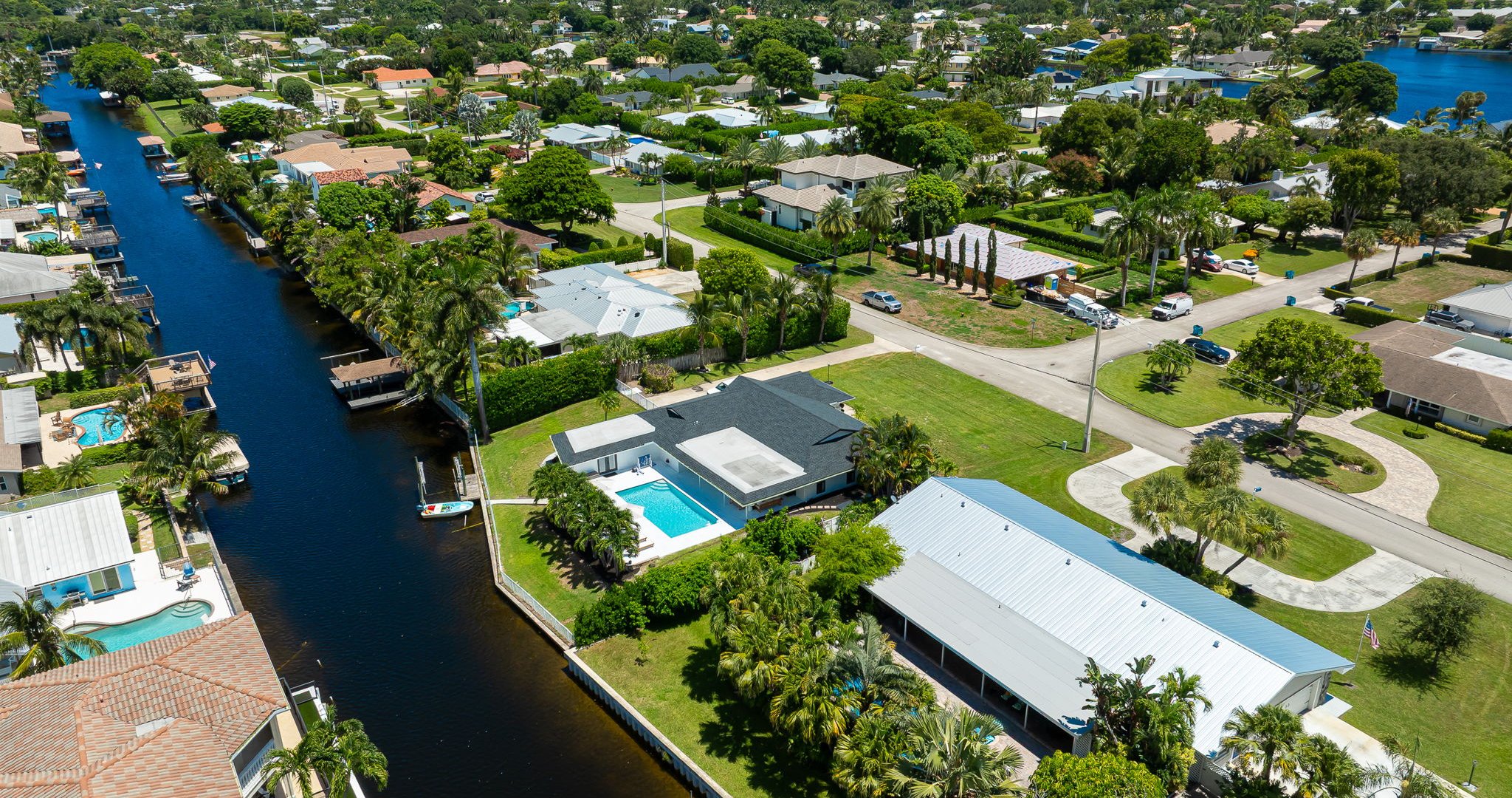 This stunning home sits along a private canal with direct access to Lake Ida, offering a true waterfront retreat. From above, you can see the sparkling pool, lush landscaping, and serene neighborhood that make this property ideal for families and groups.