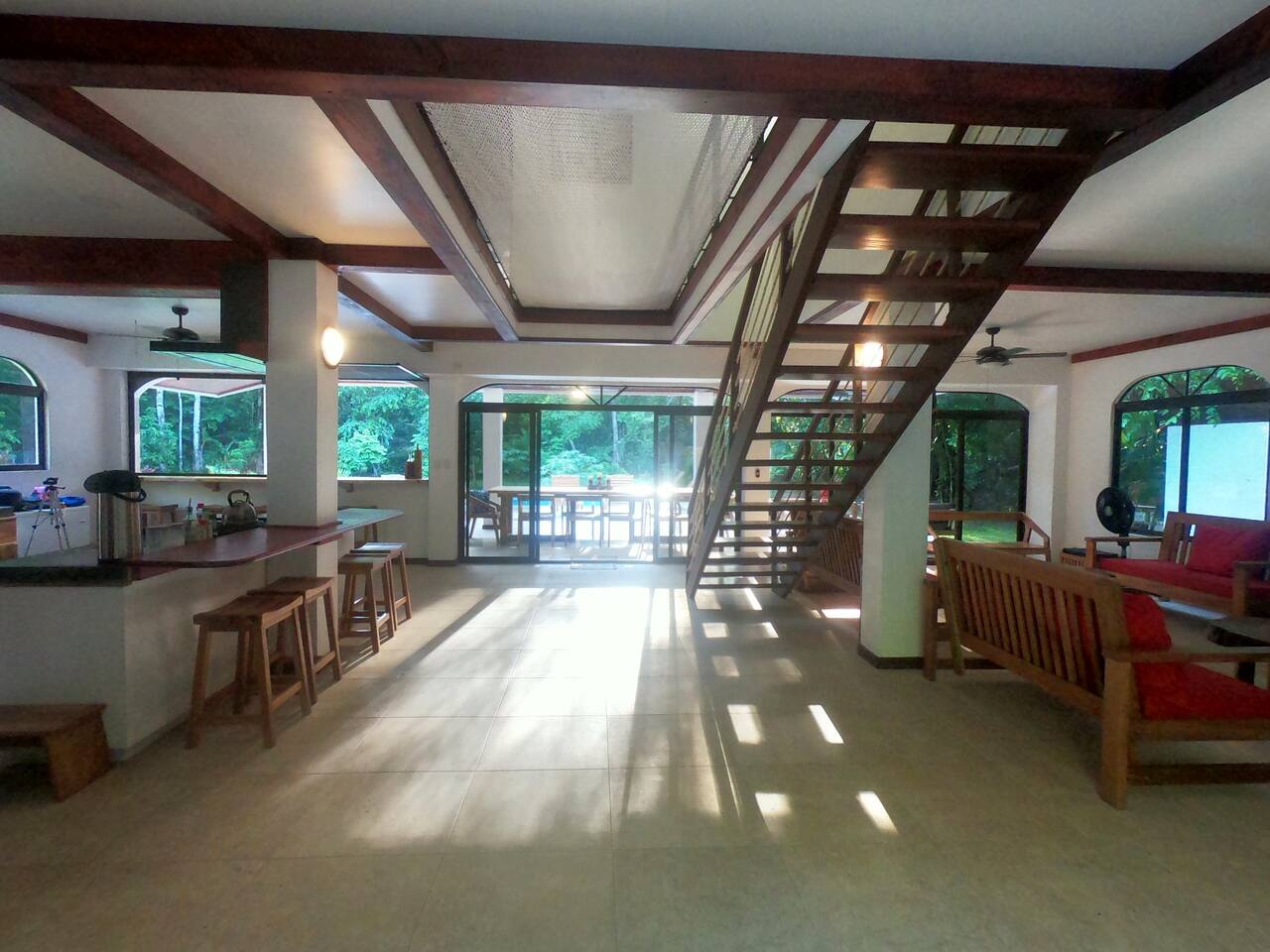 Open-concept living area with plenty of windows and outdoor spaces.