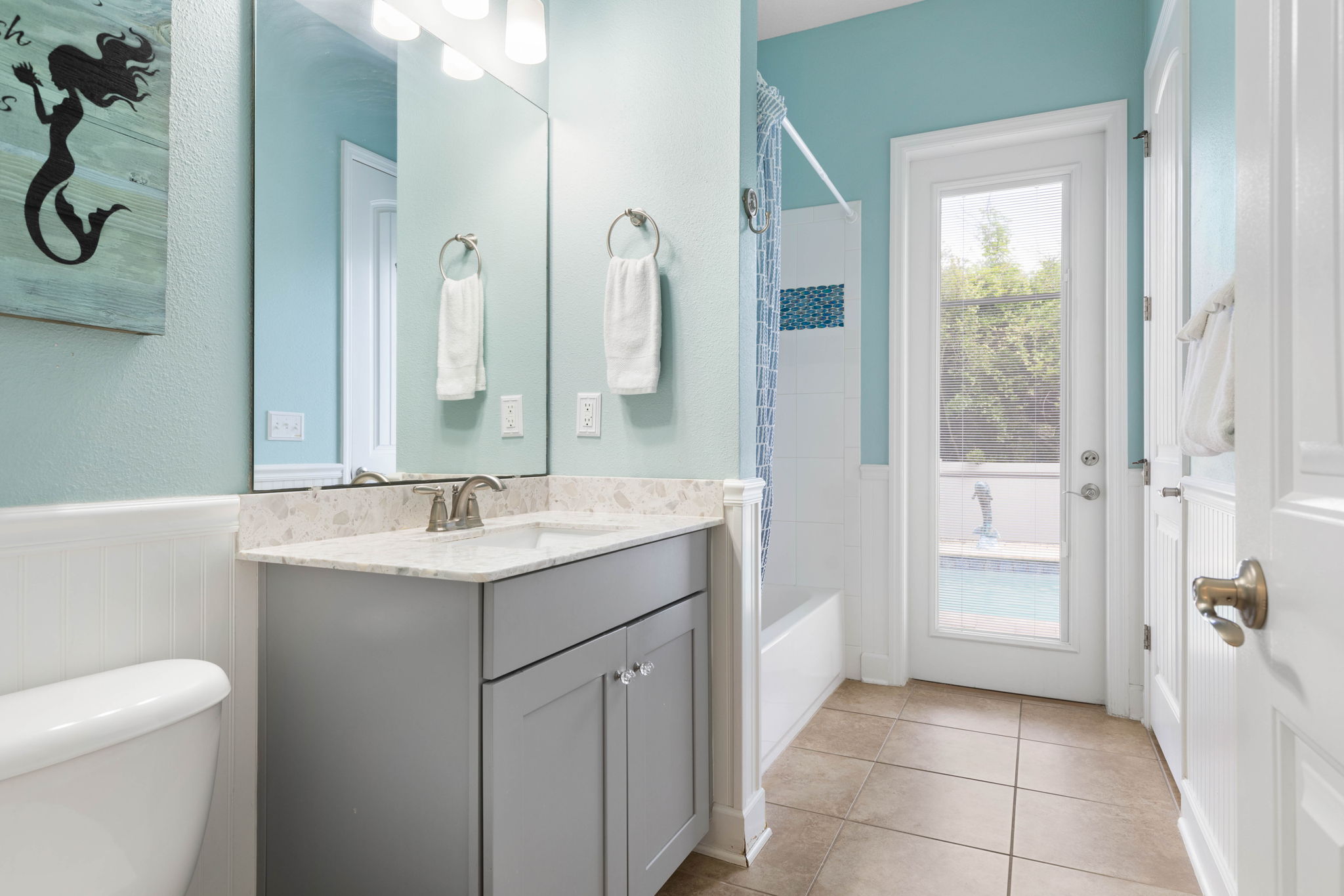 Rinse off sandy toes, start a warm bath, and glance out at the pool knowing tomorrow’s adventure is already waiting—this bright coastal bath keeps beach days easy, fresh, and wonderfully carefree.