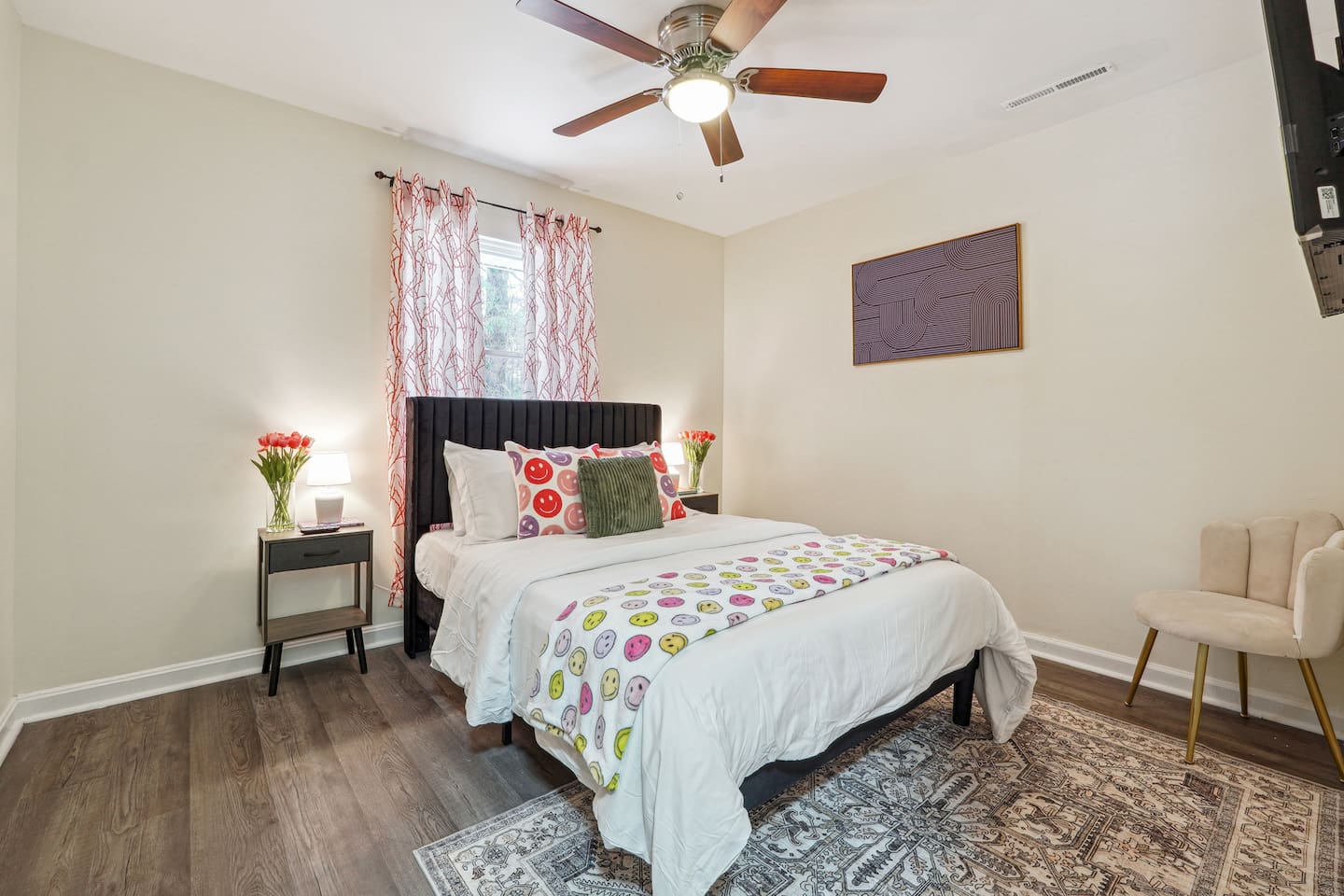 A comfortable bedroom featuring a bed, a ceiling fan, a window, a TV, and a closet — a cozy space to rest and relax.
