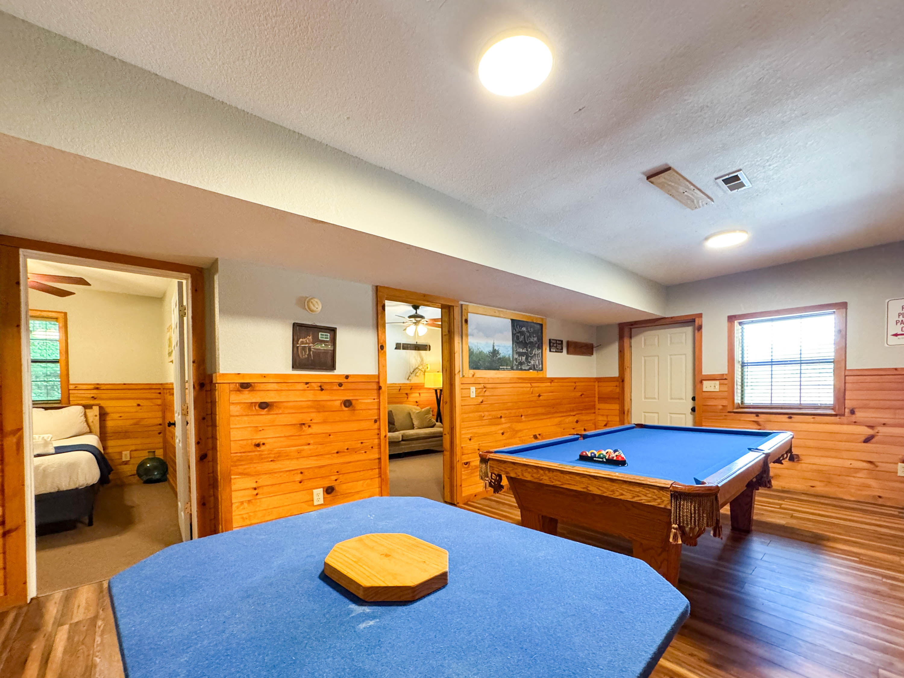 the lower level game room features a pool table and card table