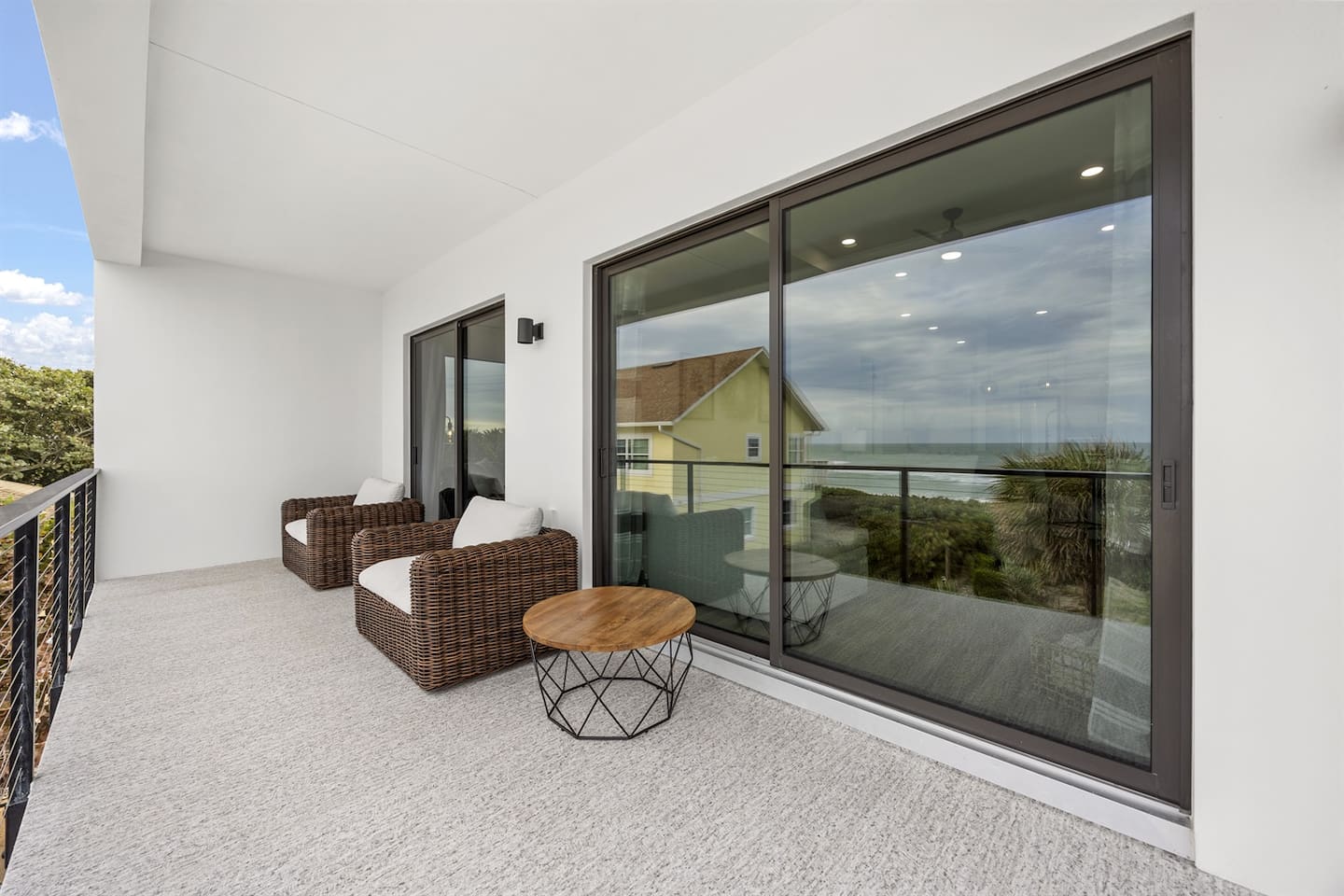 Unwind on the balcony with two comfortable chairs, perfect for enjoying the view. A little glass door behind adds a touch of elegance, offering easy access to the indoors while you relax in the fresh air.