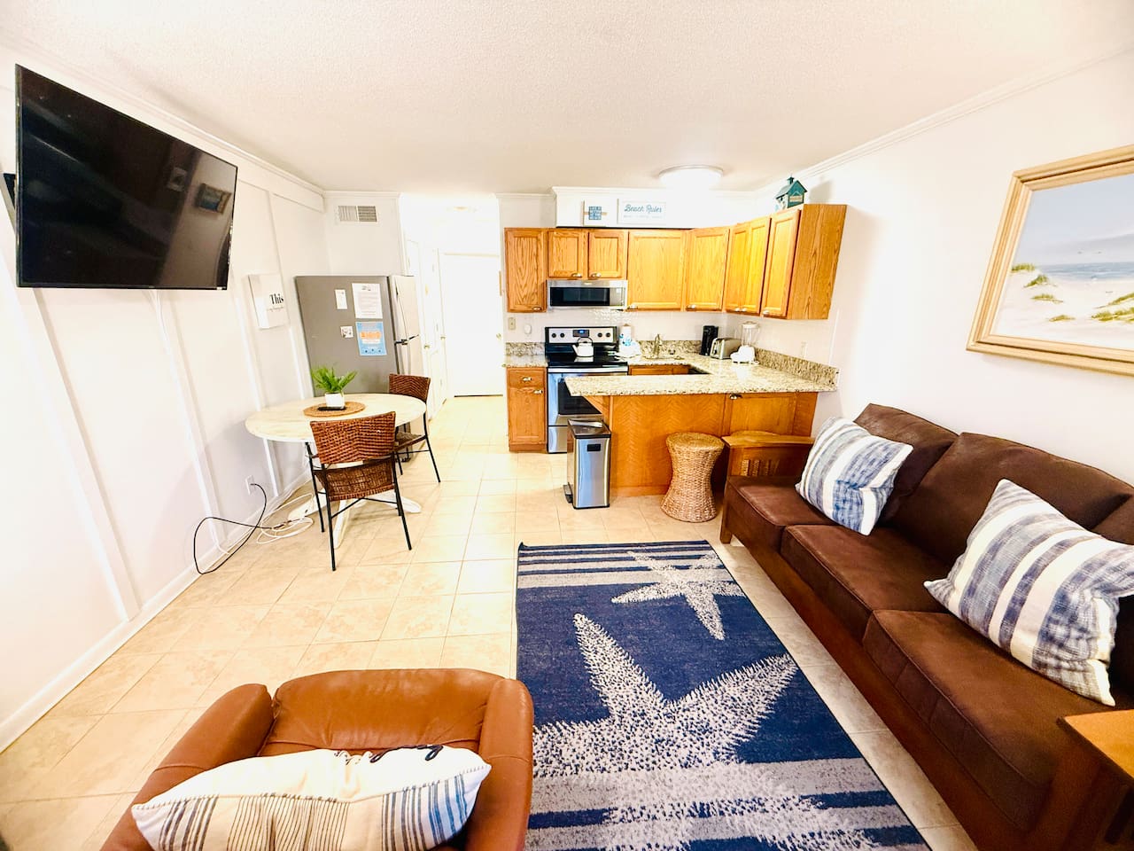 Living room with leather sofa, open to the kitchen