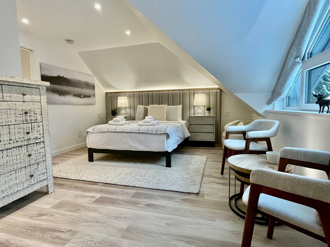 Master Bedroom#1 w/ ensuite bathroom is spacious, bright & features a seating area overlooking Fitzsimmons Creek & Whistler Mountain. Luxuries Incl: Integrated A/C & radiant floor heating, LED accent lighting, & bedside USB power outlets 