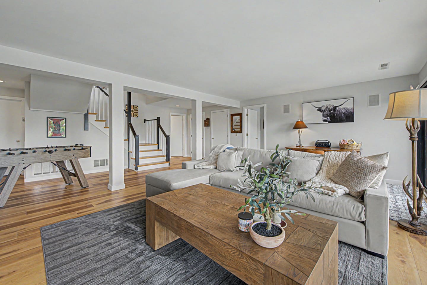 The hang-out floor. Deep sectional, easy light, the room you sink into after a day at the pool.
