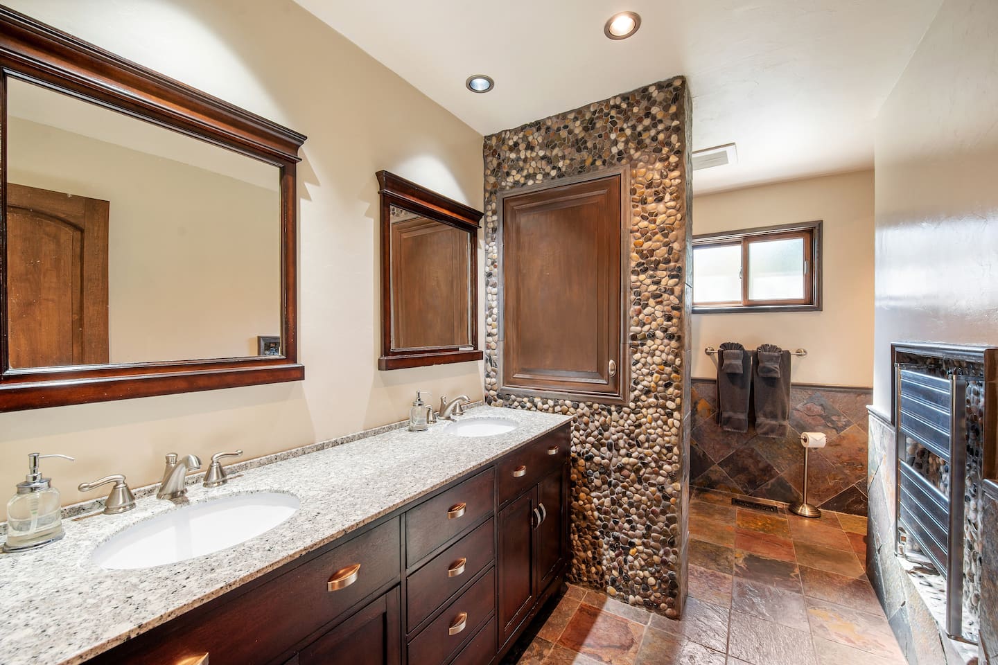 Full Guest bath with double sinks and natural stone shower