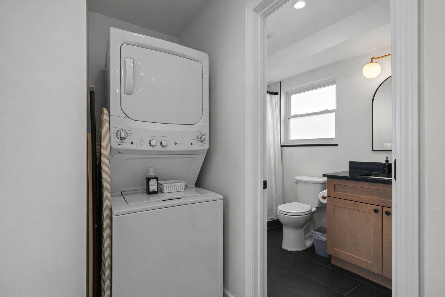 Convenient in-unit washer and dryer tucked beside a modern bathroom—making longer stays easy, comfortable, and truly hassle-free.