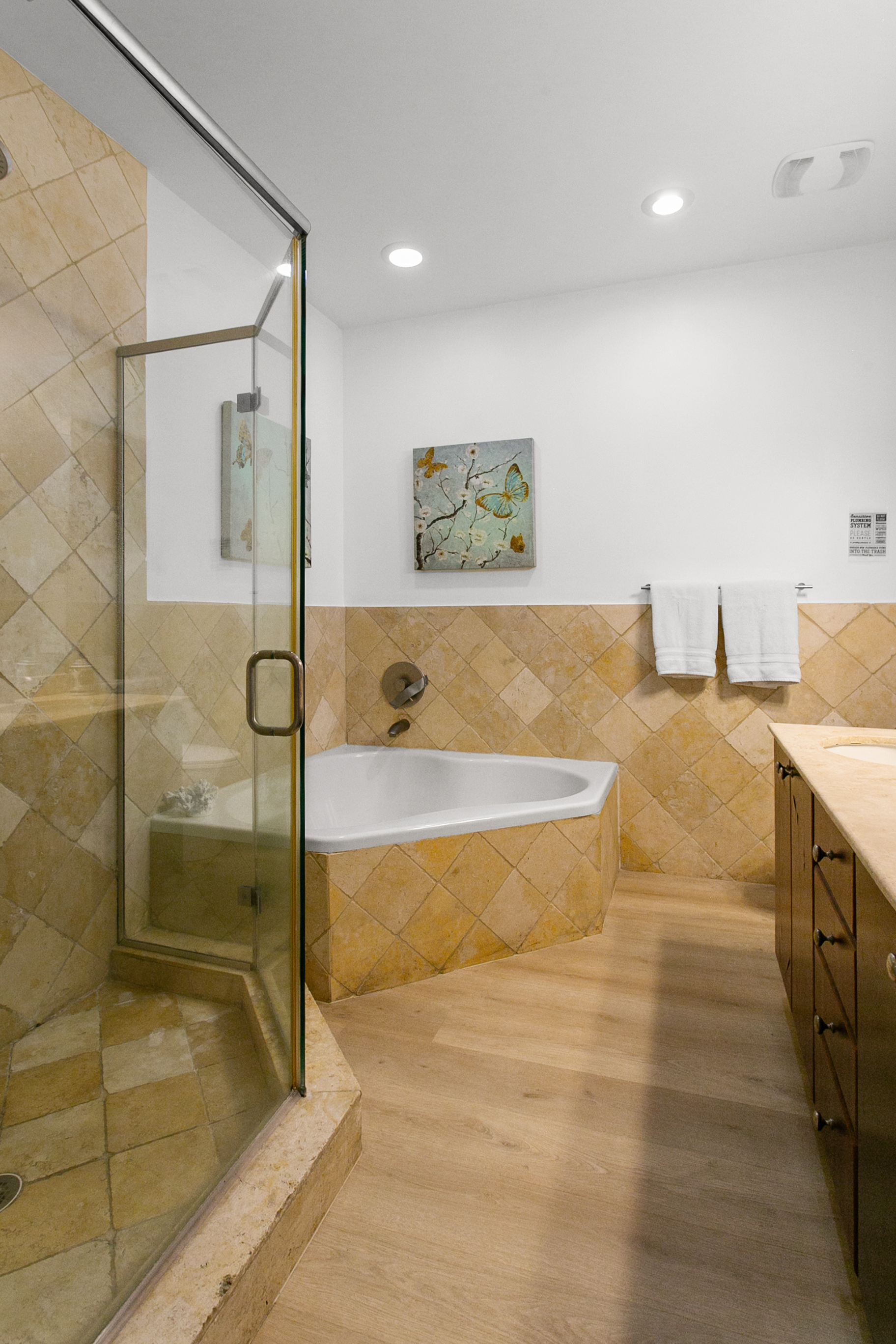 Primary Suite en-suite with separate tub and walk-in shower, double-sink vanity