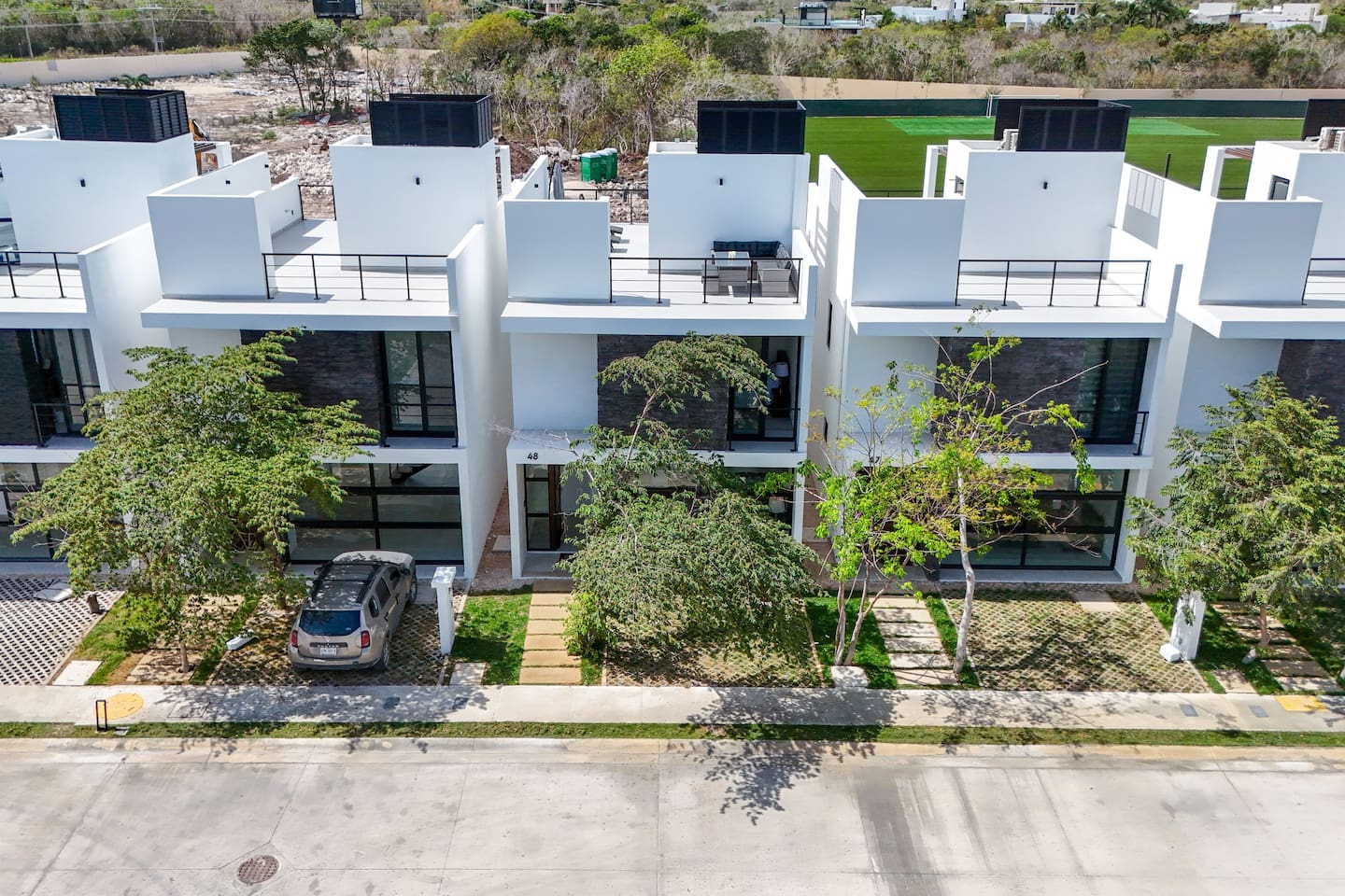The exterior of the townhouse includes the 1st level, which features a bathroom, kitchen, living room, dining room, and a walkout to the backyard.