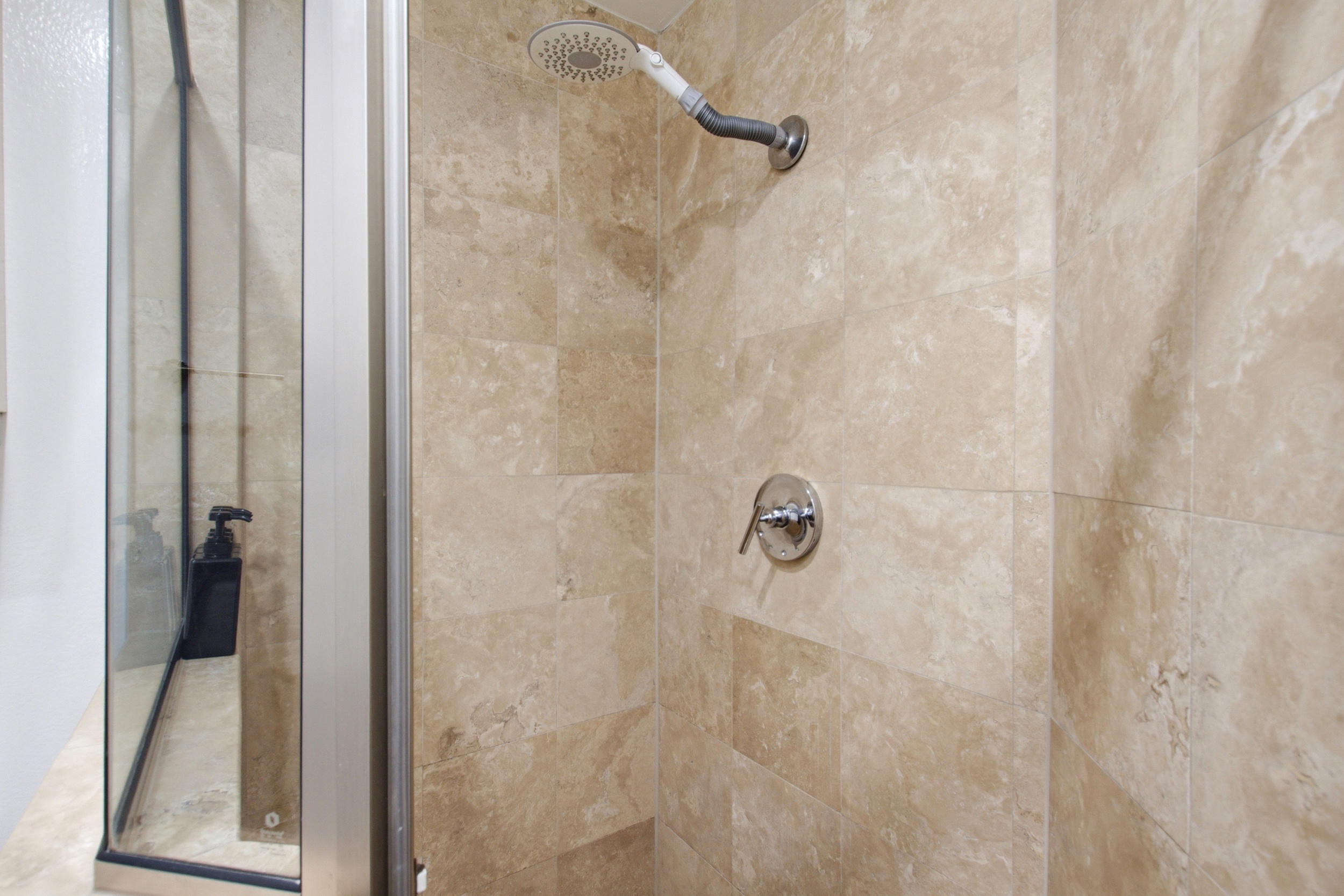 Refresh in the elegant tiled shower with modern fixtures for a spa-like experience!