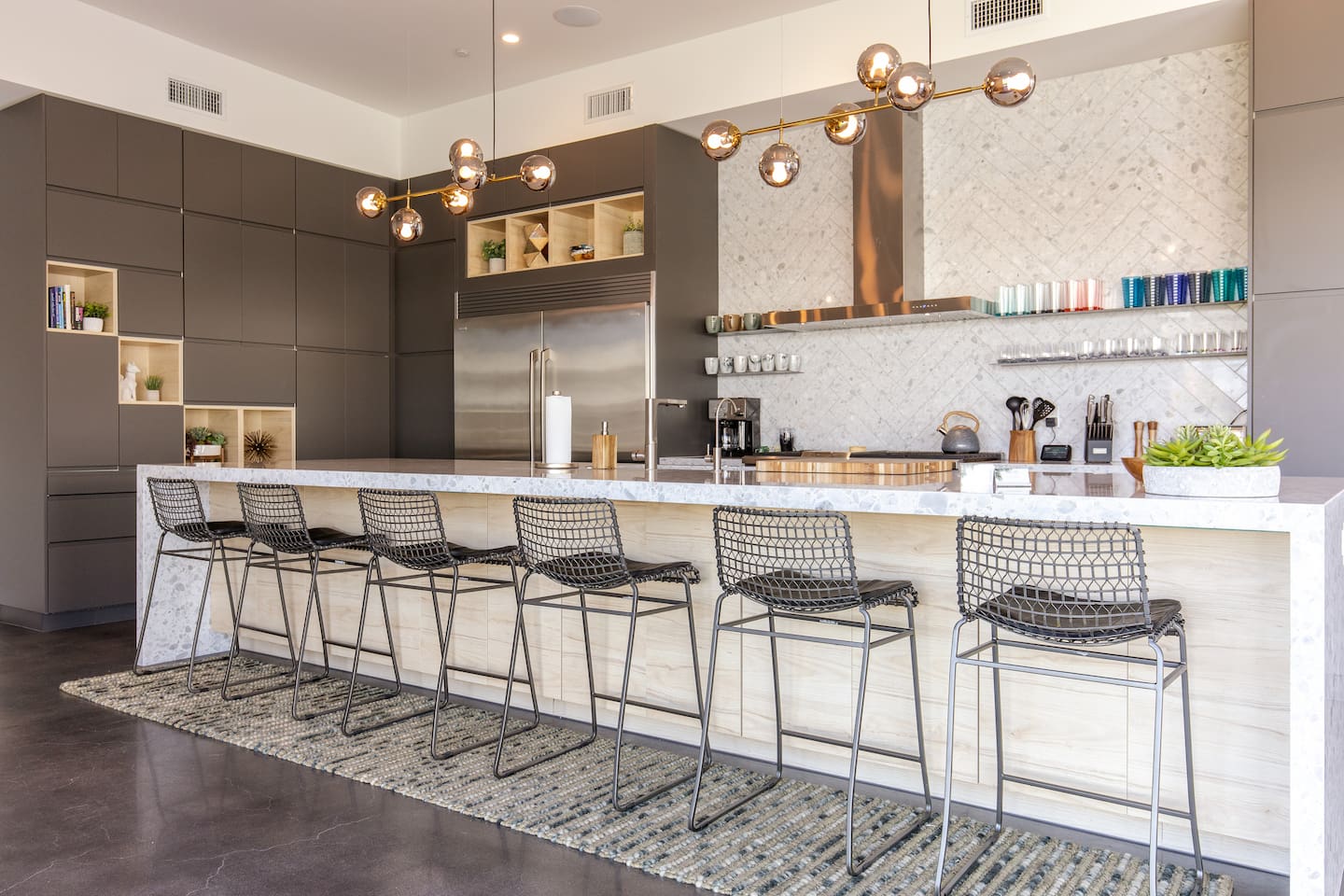 Large well stocked entertainer's kitchen + bar seating