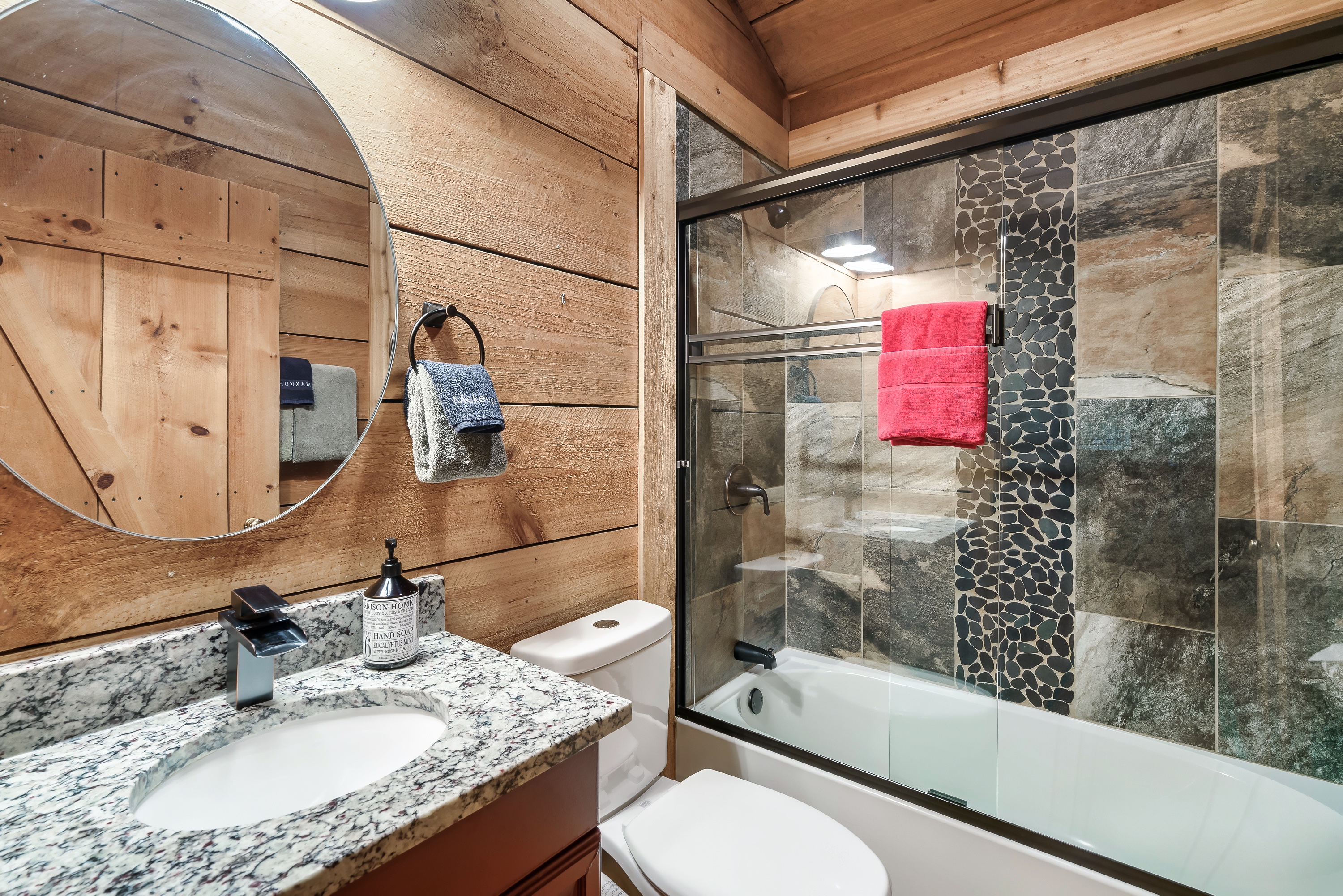 Modern bathroom with granite counters and walk-in shower