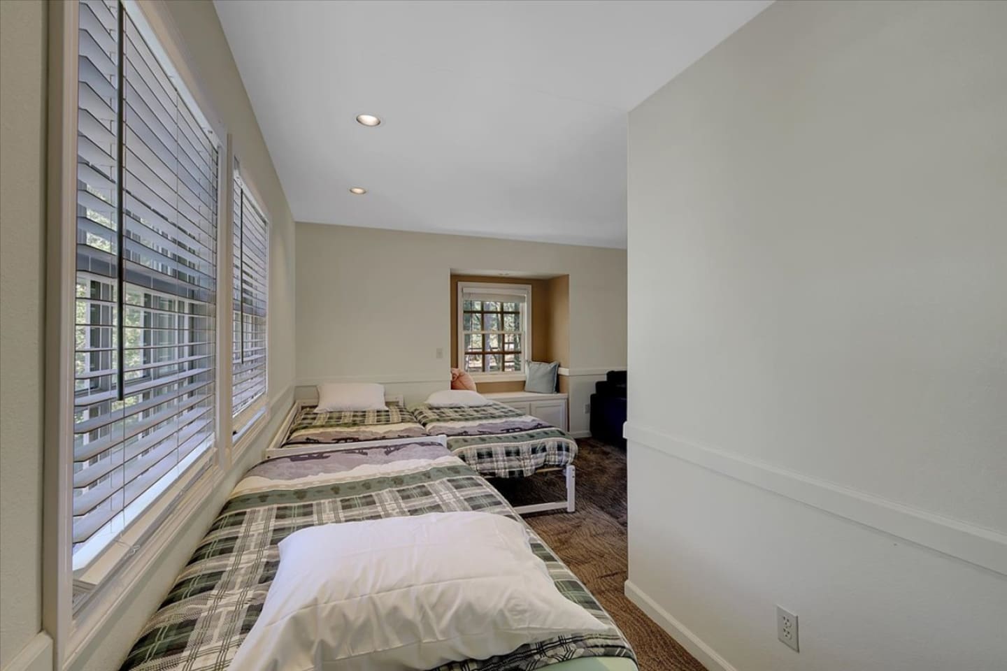 Bedroom 3 with three twin beds and a simple setup for kids, friends, or extra guests.
