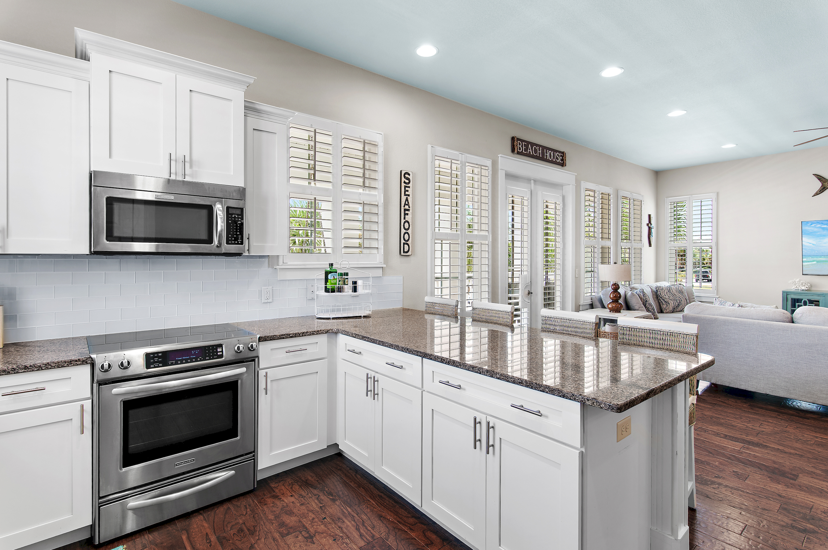 Bright, fully equipped kitchen with generous counter space, modern appliances, and a seamless open layout.
