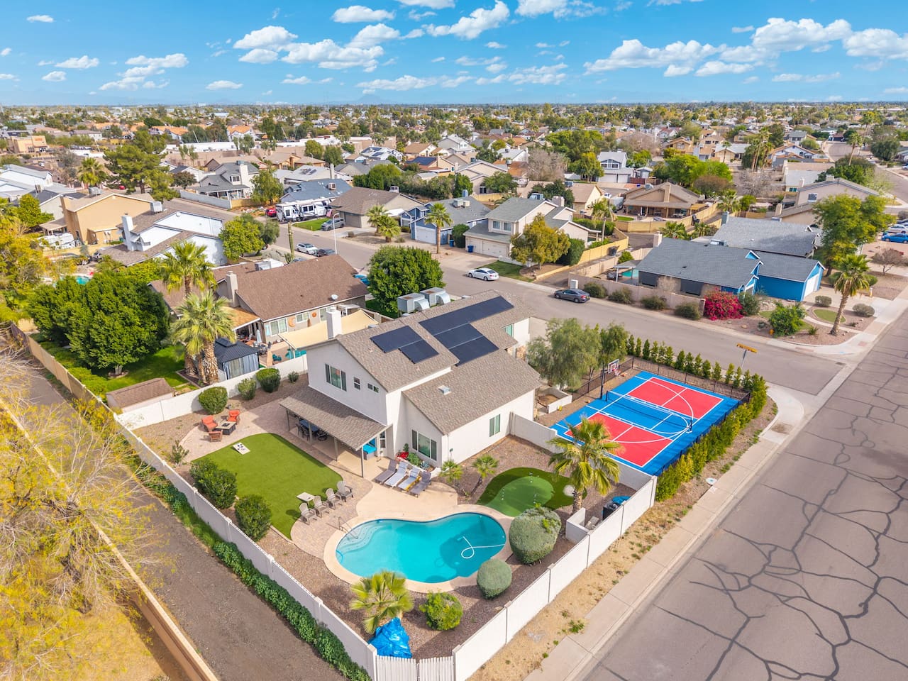 An entertainer's dream from above — pool, court, and space to spare.