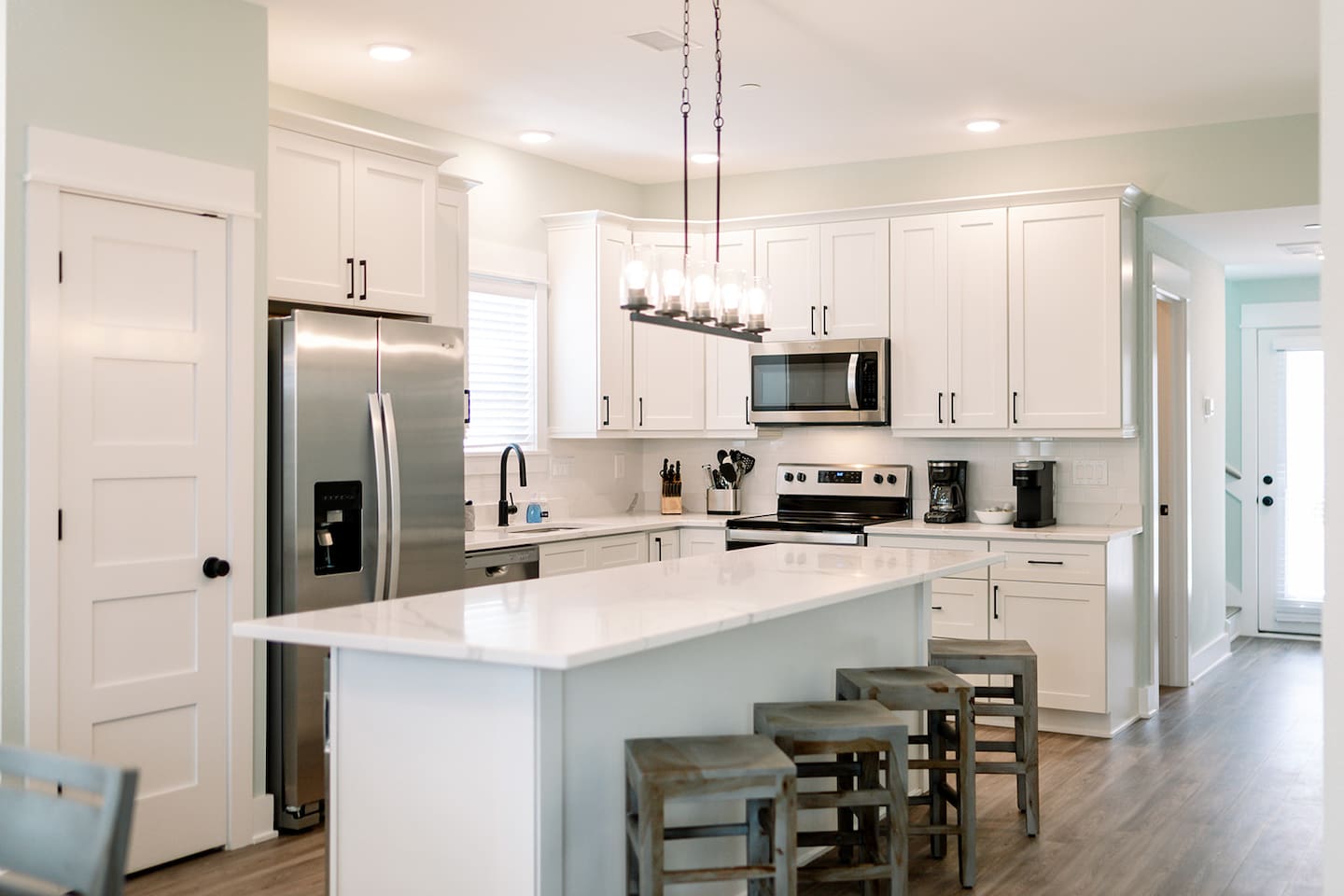 Bright coastal kitchen featuring stainless steel appliances and generous prep space.