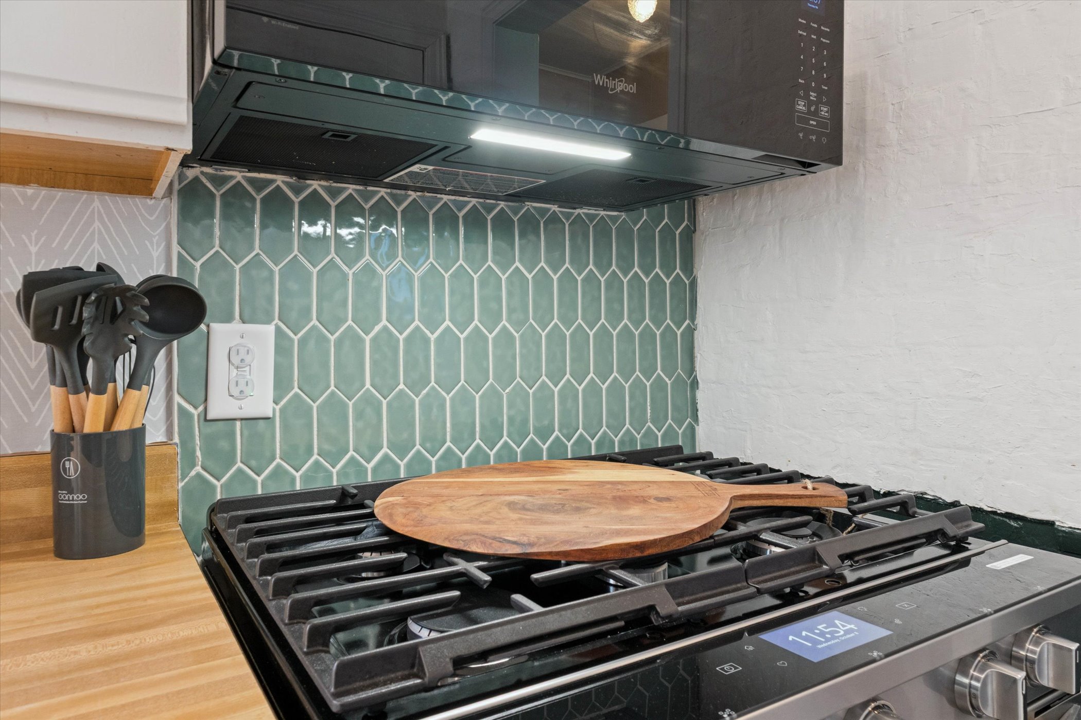 Sleek meets savory—our South Bend kitchen features new stainless steel Whirlpool appliances and a wooden pizza peel, perfect for prepping alfresco pies and family-style meals with ease.