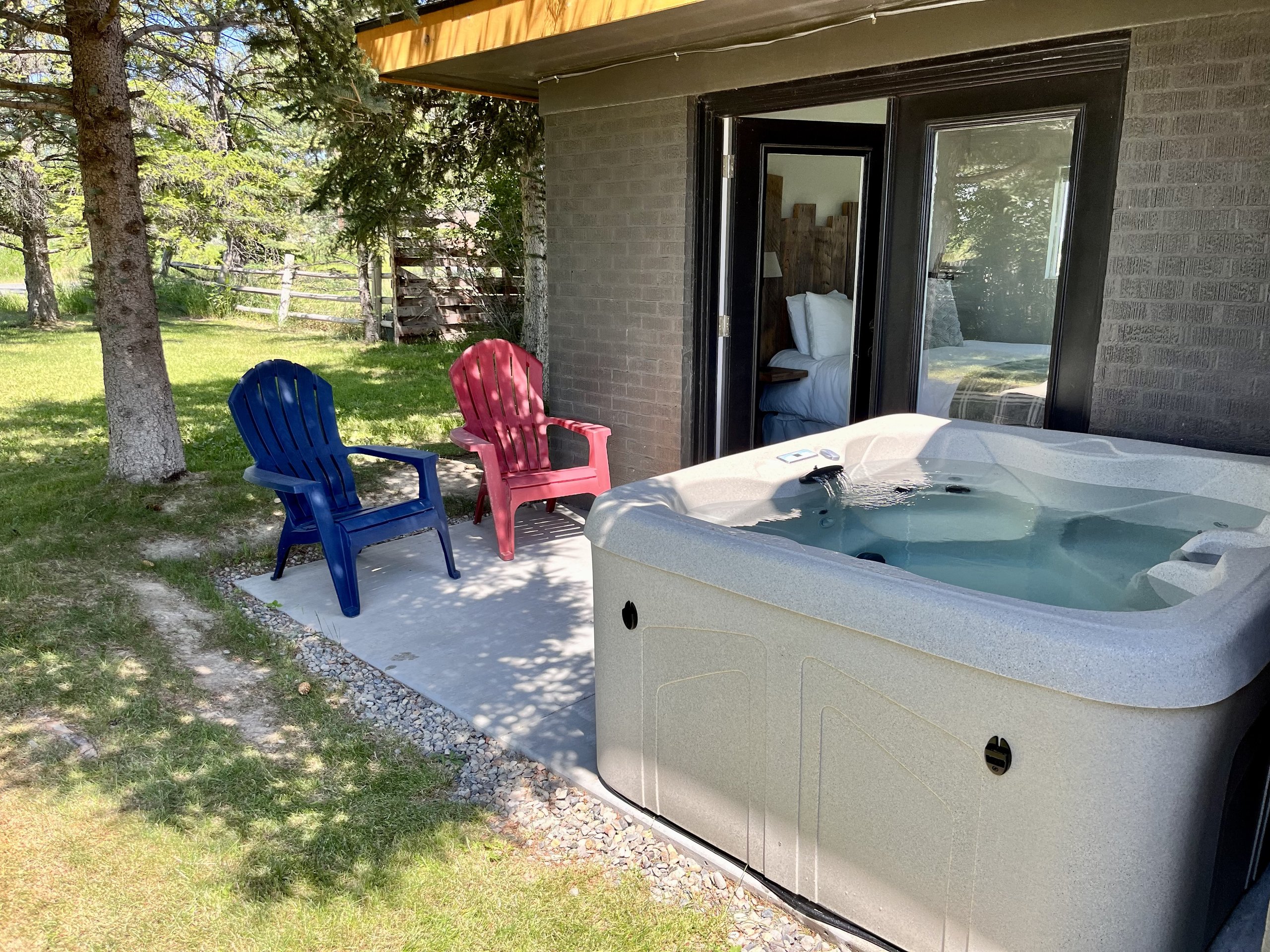 Private hot tub steps from the patio — soak under the stars