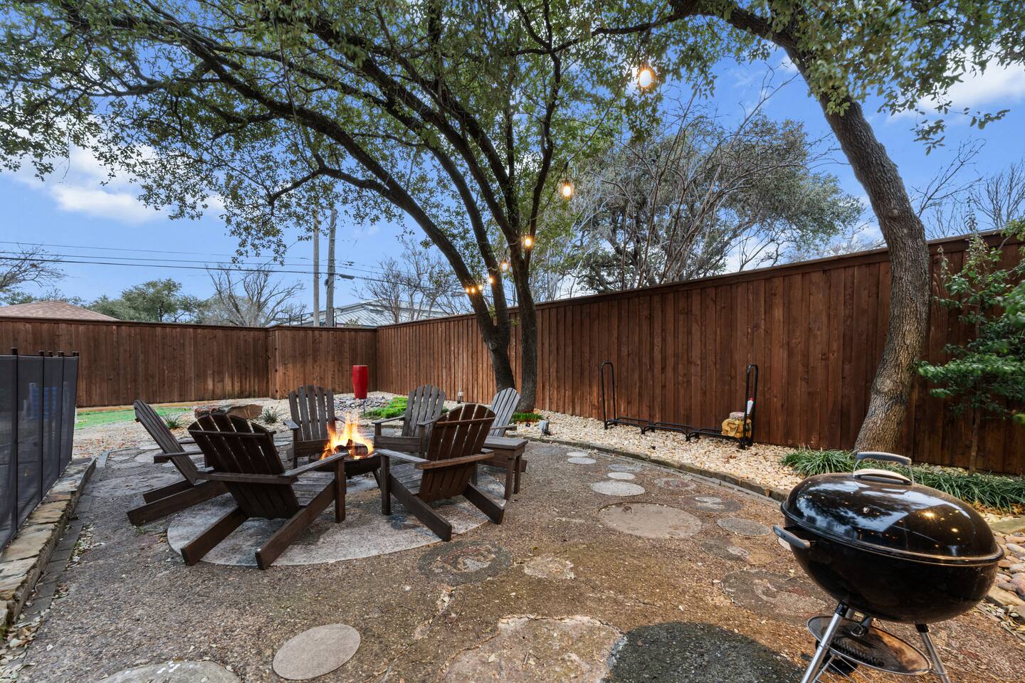 Make memories around the fire pit under string lights and towering trees.