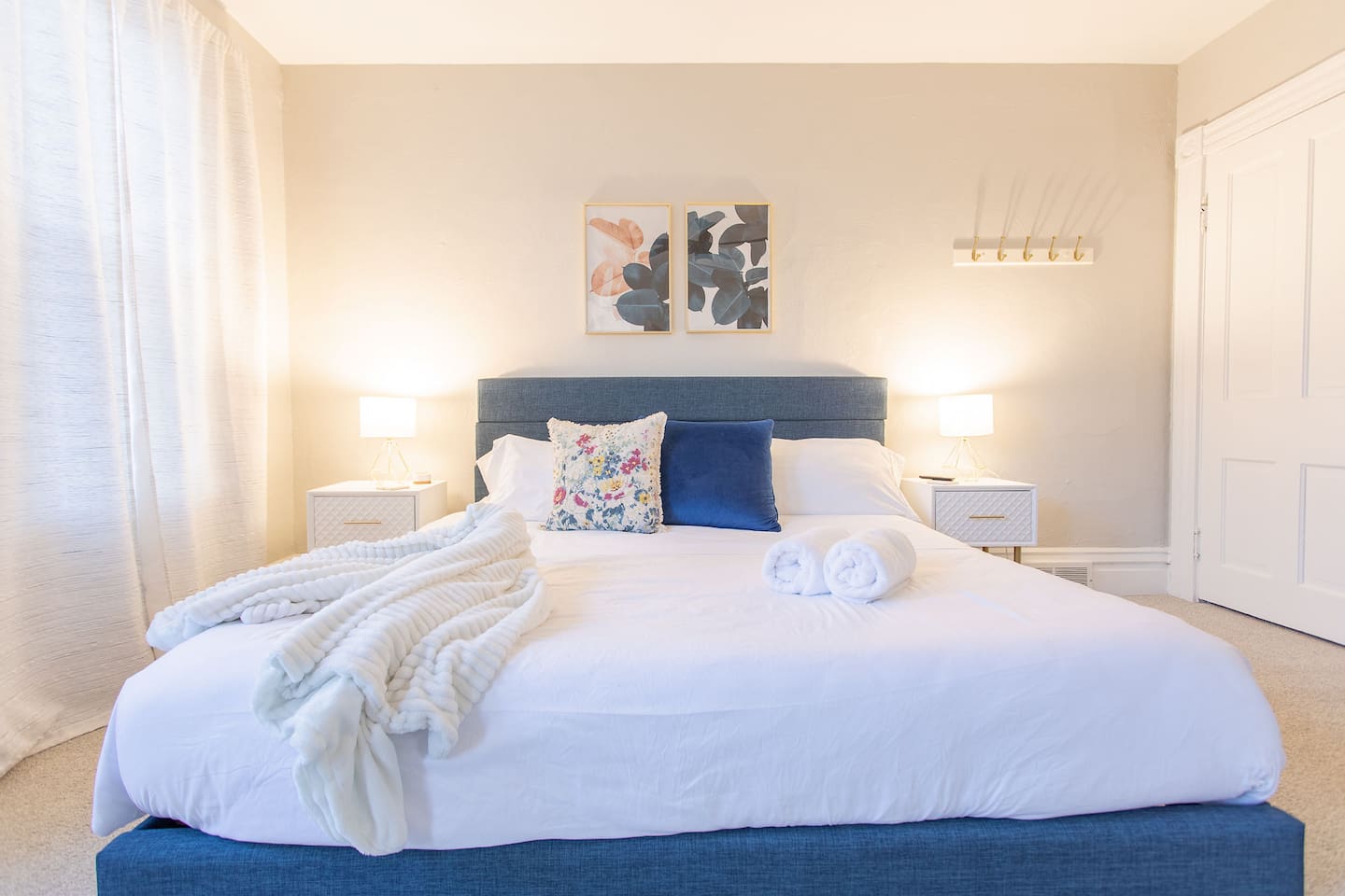 Discover the King Bedroom, a spacious room on the second floor with king bed flanked by nightstands with lamps.