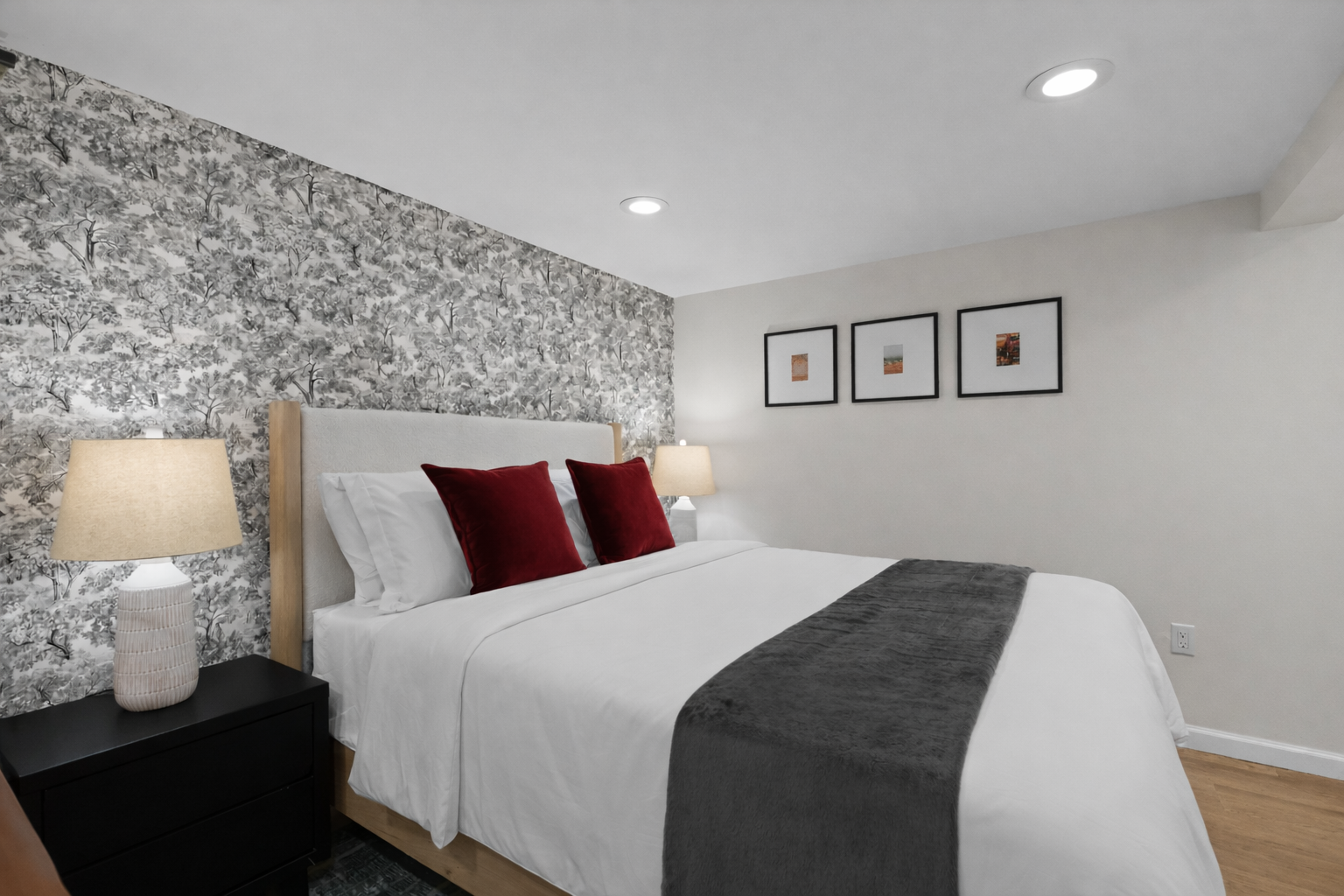 Unwind in a serene bedroom with a plush bed, crisp white linens, soft lighting, and a stylish accent wall for a peaceful night’s rest.