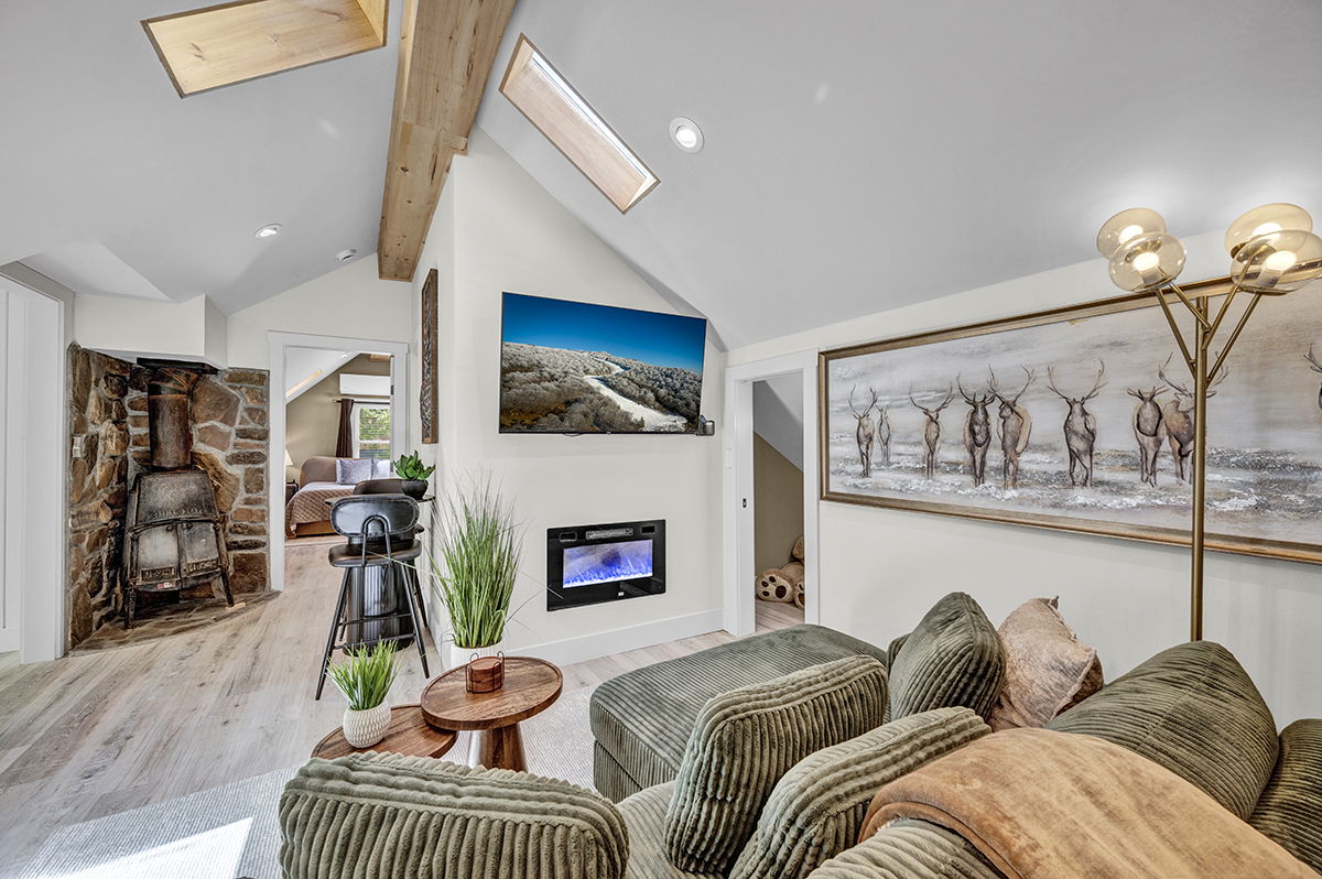 Cozy Living Room with 55-inch Smart TV, Fireplace, and bistro table.