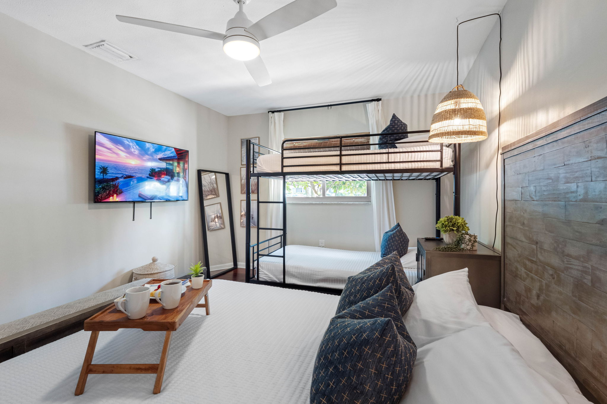 Family-friendly bedroom featuring a full bed and bunk beds, perfect for guests or kids.