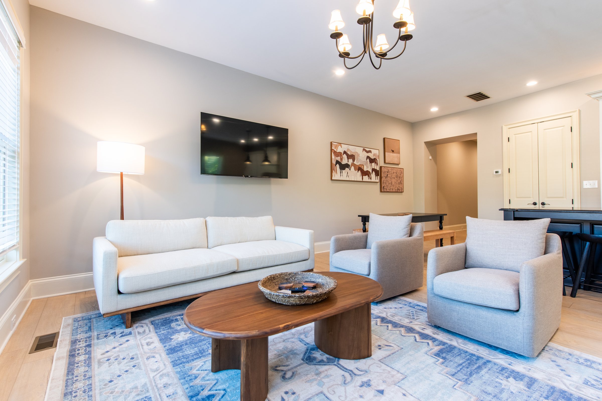 Comfortable seating with a wall-mounted TV, ideal for movie nights.