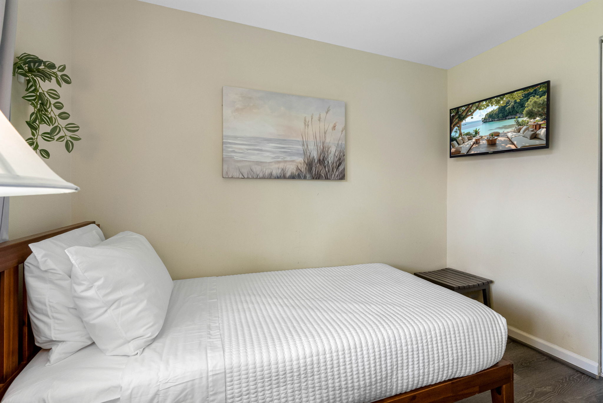 Set against warm, neutral walls and stylish wood-look flooring, the space feels both modern and relaxing.