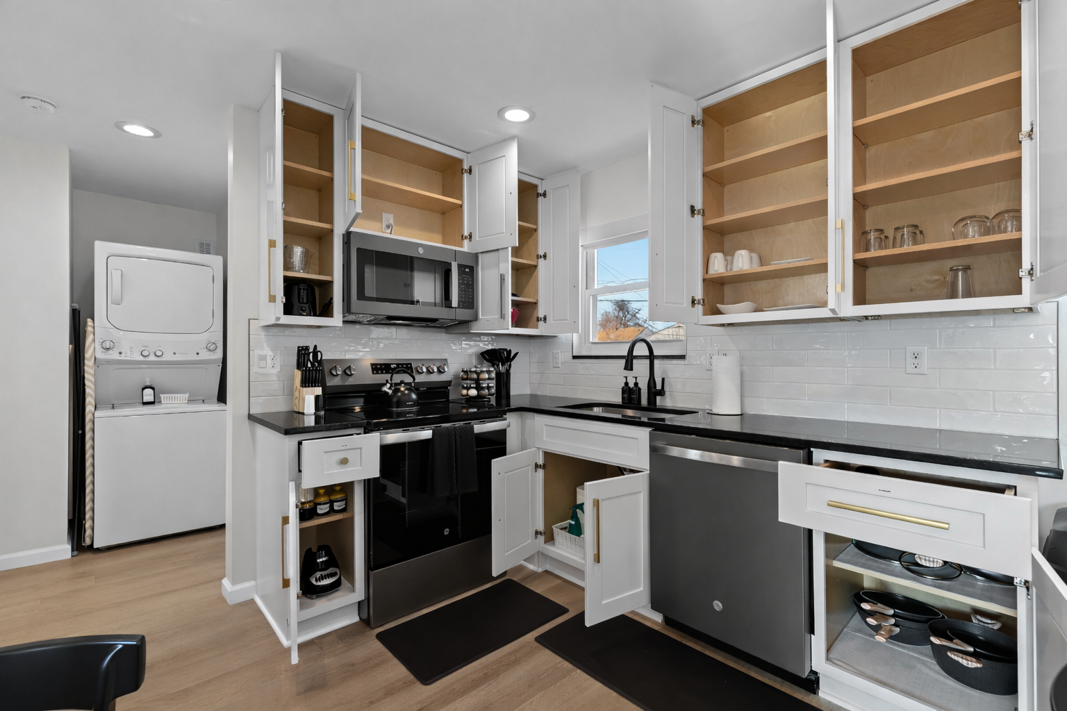 Fully stocked kitchen with ample cabinet storage, modern appliances, and everything you need for easy cooking, dining, and extended stays.