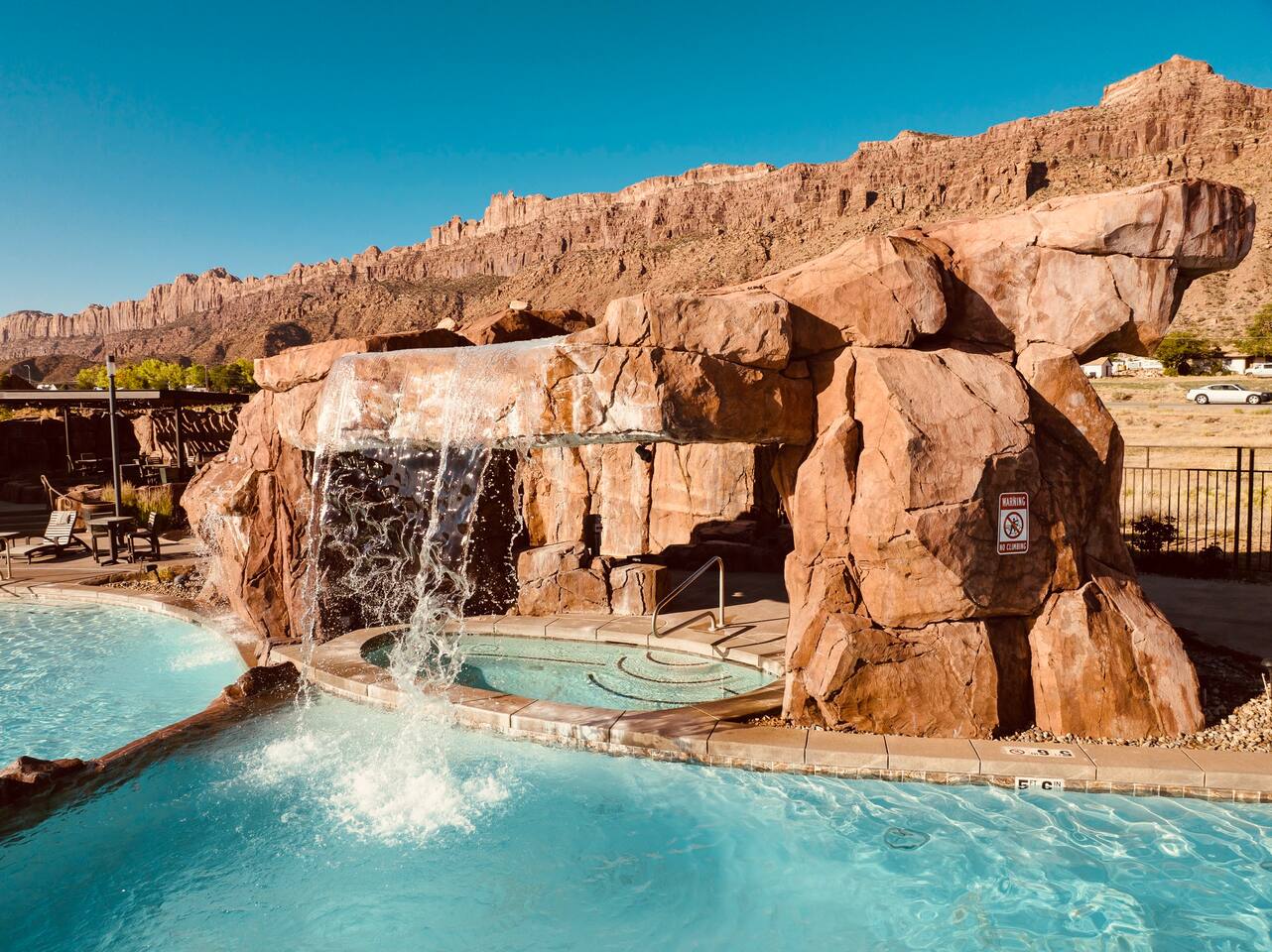 Waterfall flowing over the hidden grotto hot tub