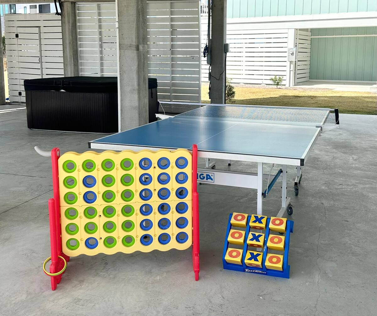 A beach wagon, ping-pong table, and a variety of lawn games are provided to keep the fun going from the sand to the backyard.