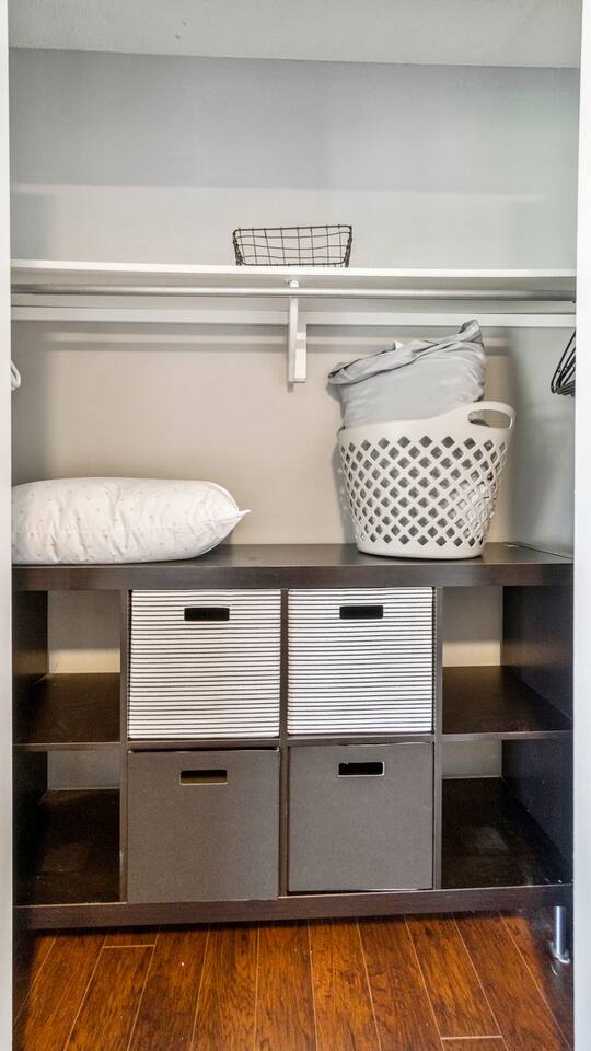This oversized closet offers hanging space, extra linens, a laundry basket, and smart storage cubes—ideal for extended stays or traveling families.