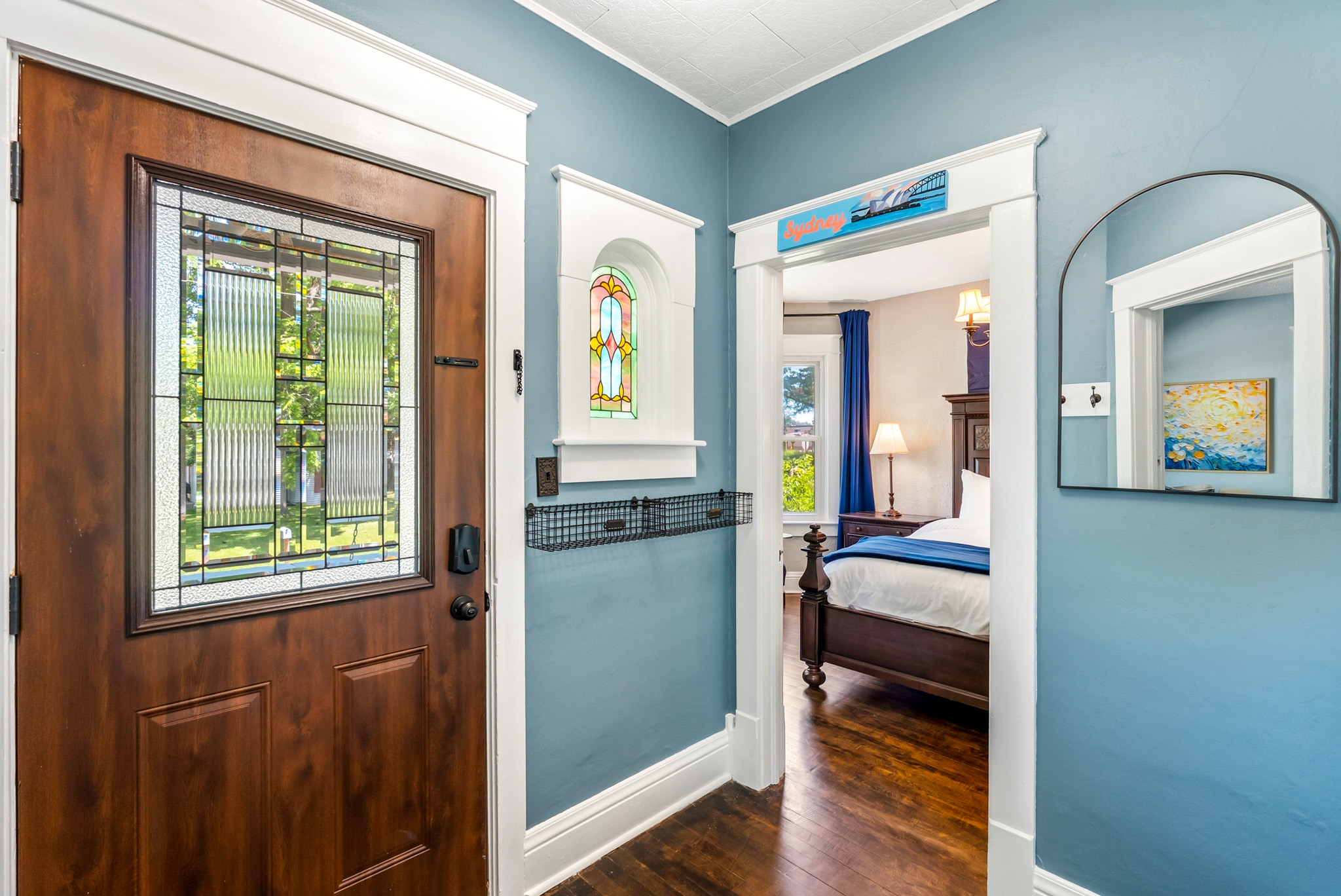 Welcome to Wanderer's Rest. A peek from our bright front entryway reveals the easy, seamless flow directly into the main-floor Sydney King bedroom.