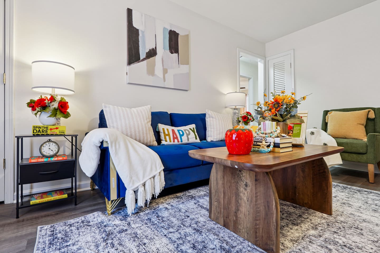 The living room features cozy furniture, including a comfortable blue couch, and an Amazon Fire-powered Smart TV for your entertainment. You’ll also find the Xfinity modem conveniently located here, convenient for ethernet connection.